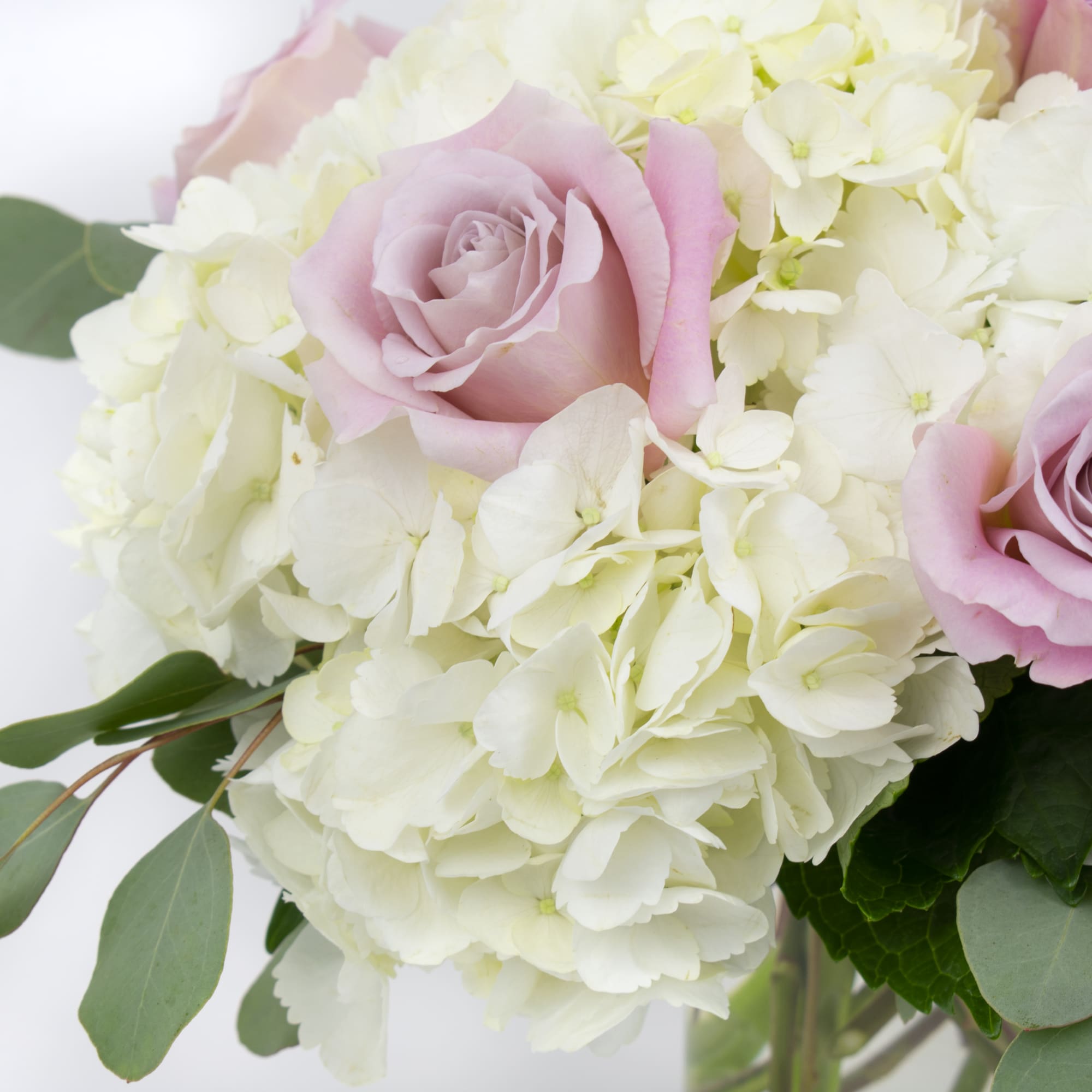 Pink roses in a white hydrangea bouquet, photo 2 of 4