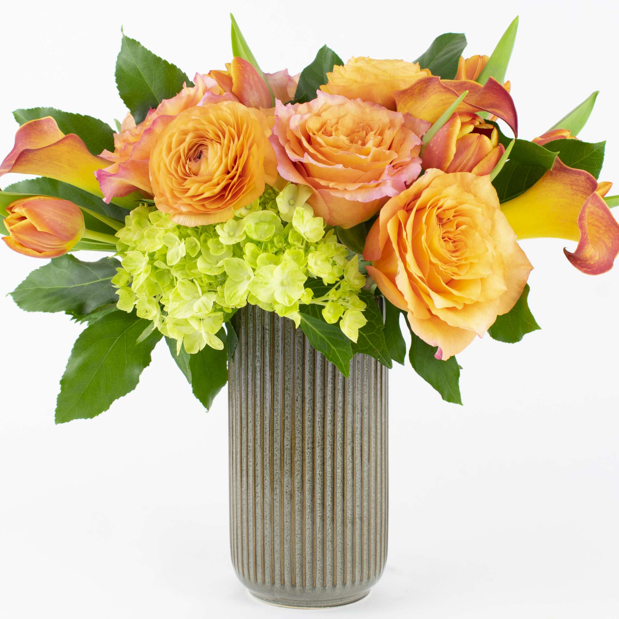 Orange roses and calla lilies in a ribbed vase, photo 3 of 4