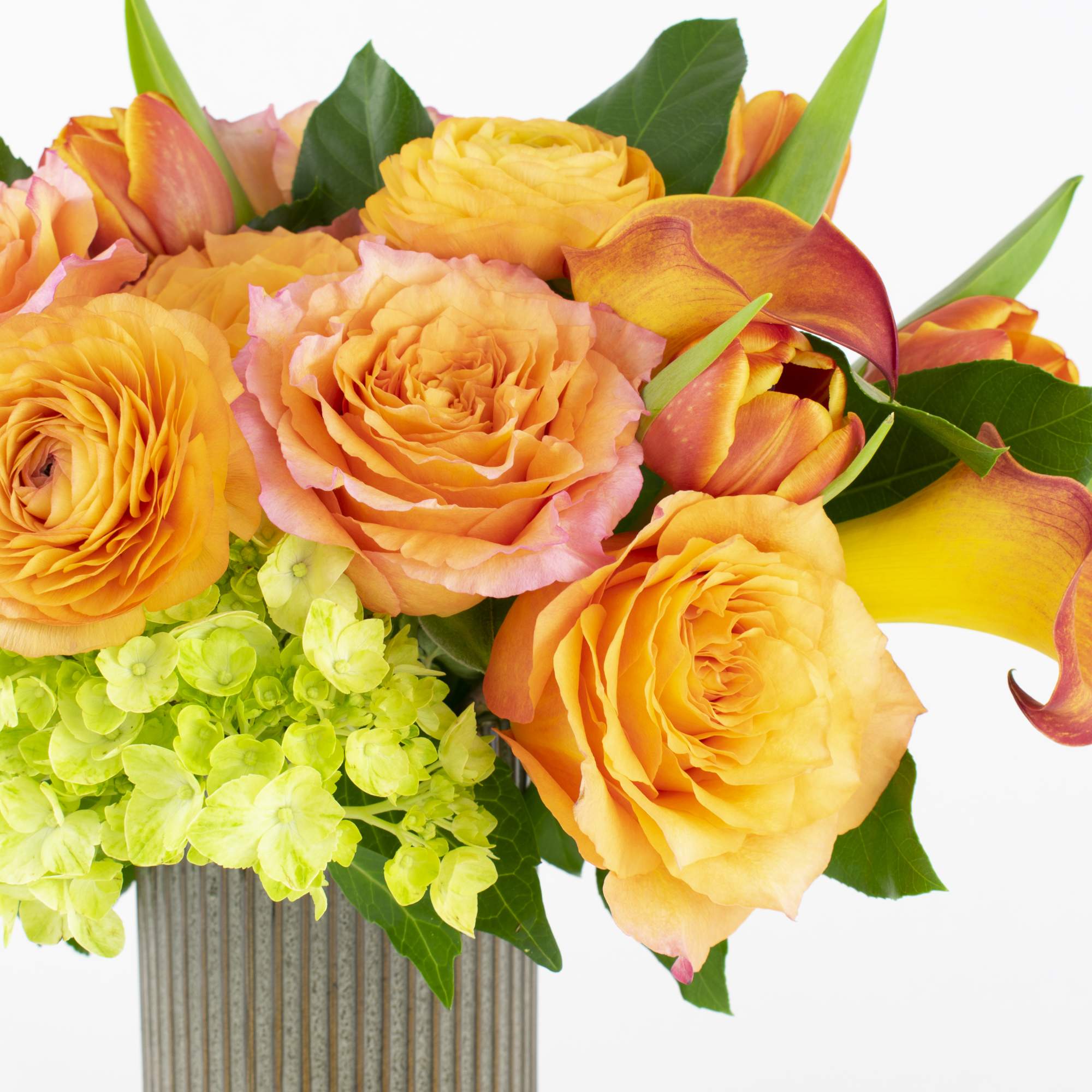 Orange roses and calla lilies in a ribbed vase, photo 2 of 4
