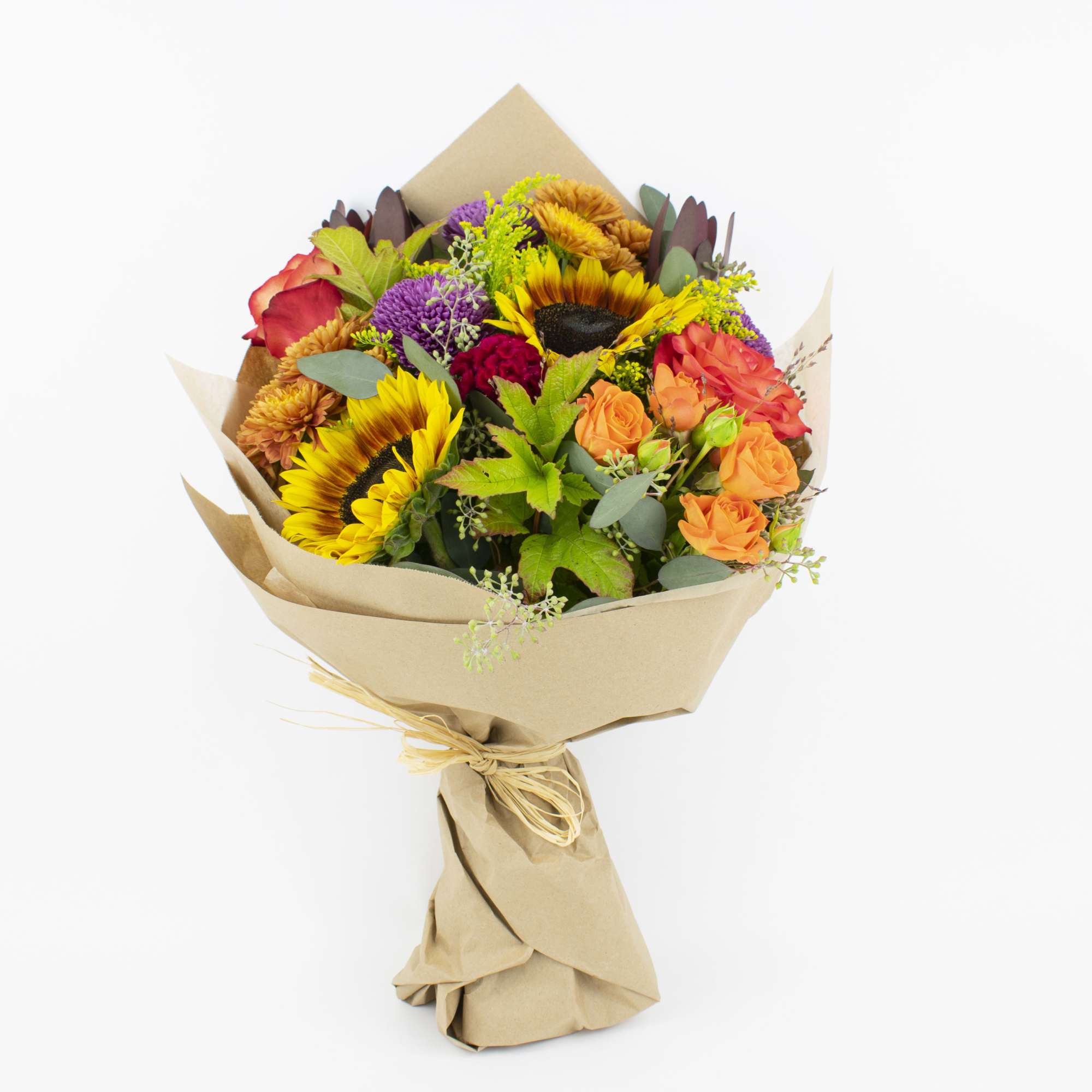 Mixed bouquet with sunflowers, roses, and chrysanthemums wrapped in kraft paper