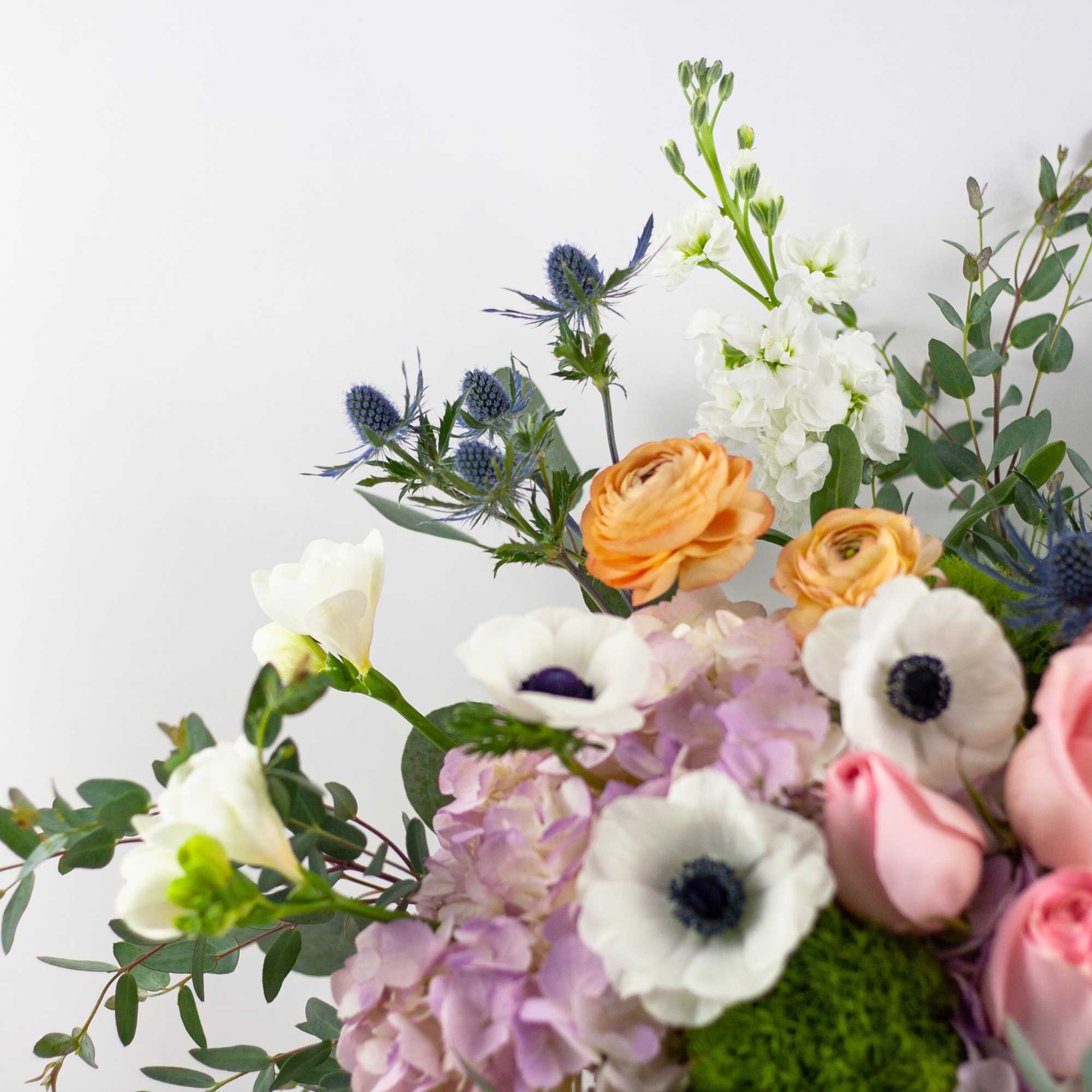 Mixed bouquet with pink roses, white anemones, and orange ranunculus, photo 2 of 4