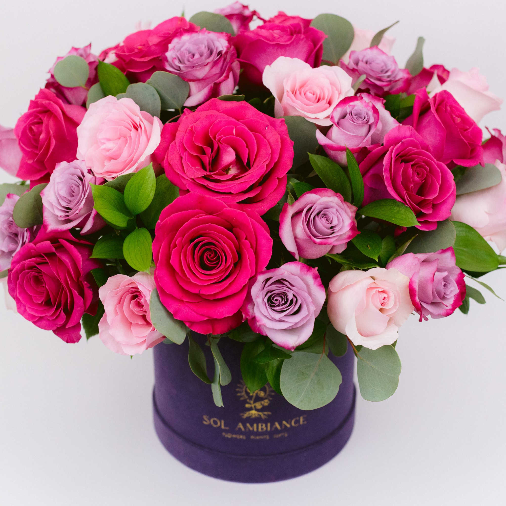 Pink and lavender roses arranged in a purple hat box, photo 3 of 4
