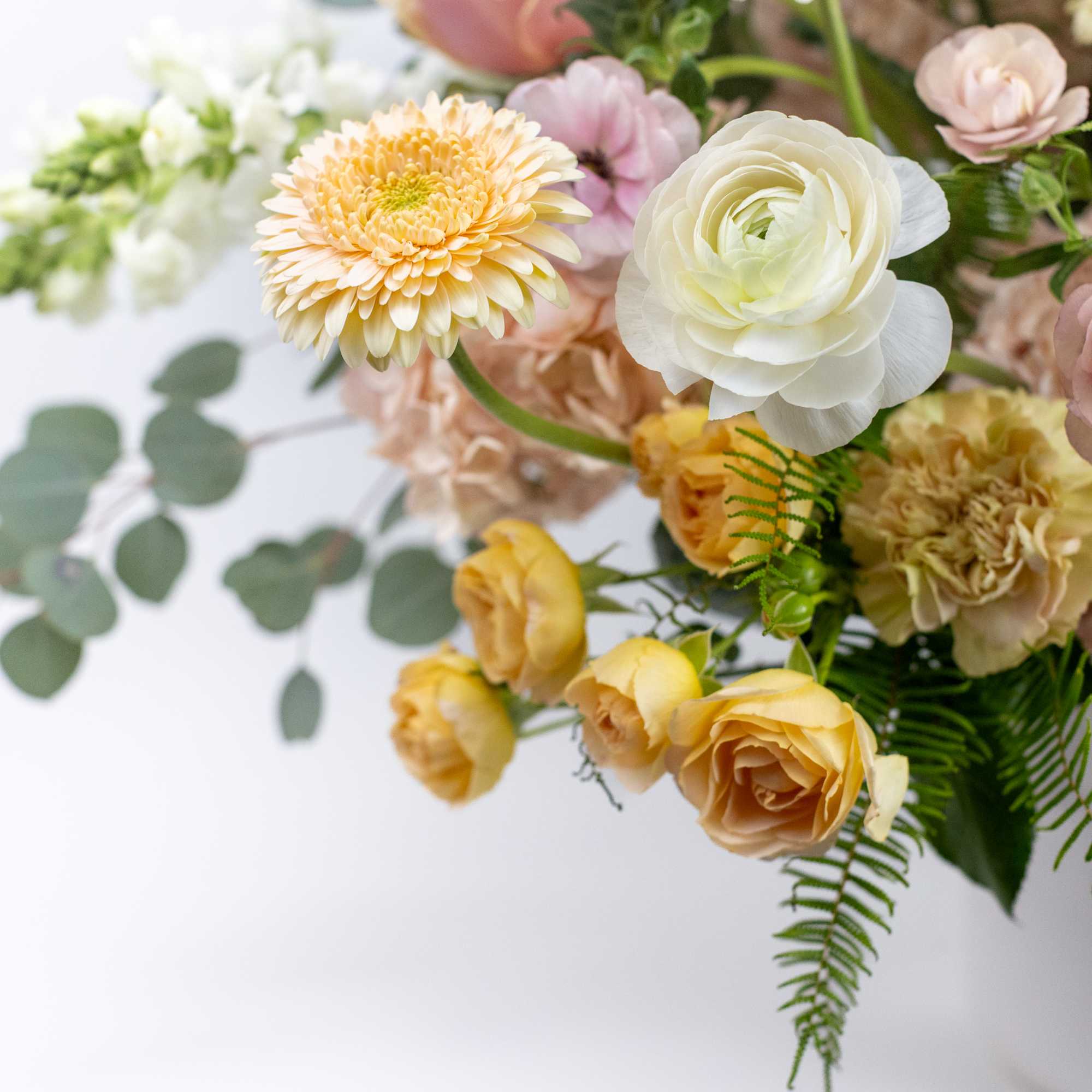 Pastel bouquet with white, pink, and yellow flowers