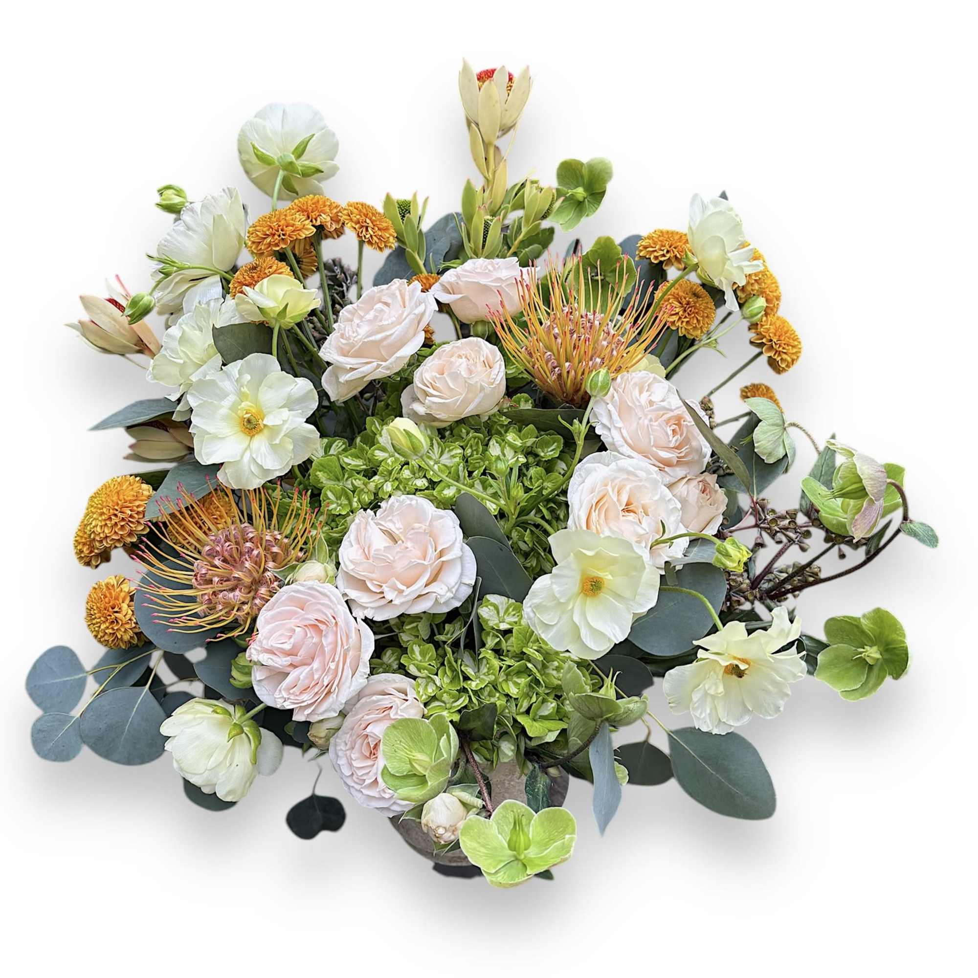 Mixed bouquet with pale roses, white blooms, and orange accents