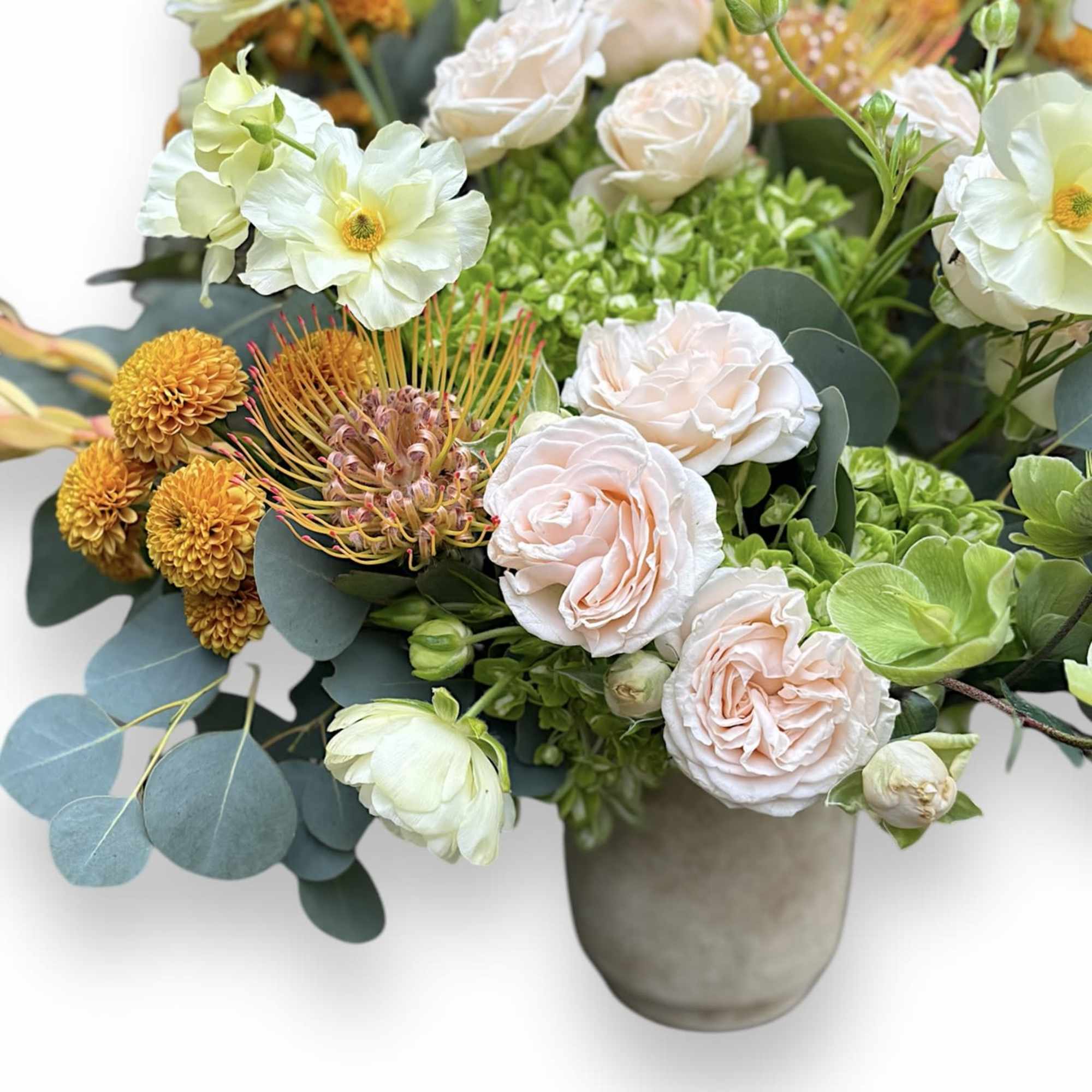 Mixed bouquet in a gray vase with pale pink roses and white blooms