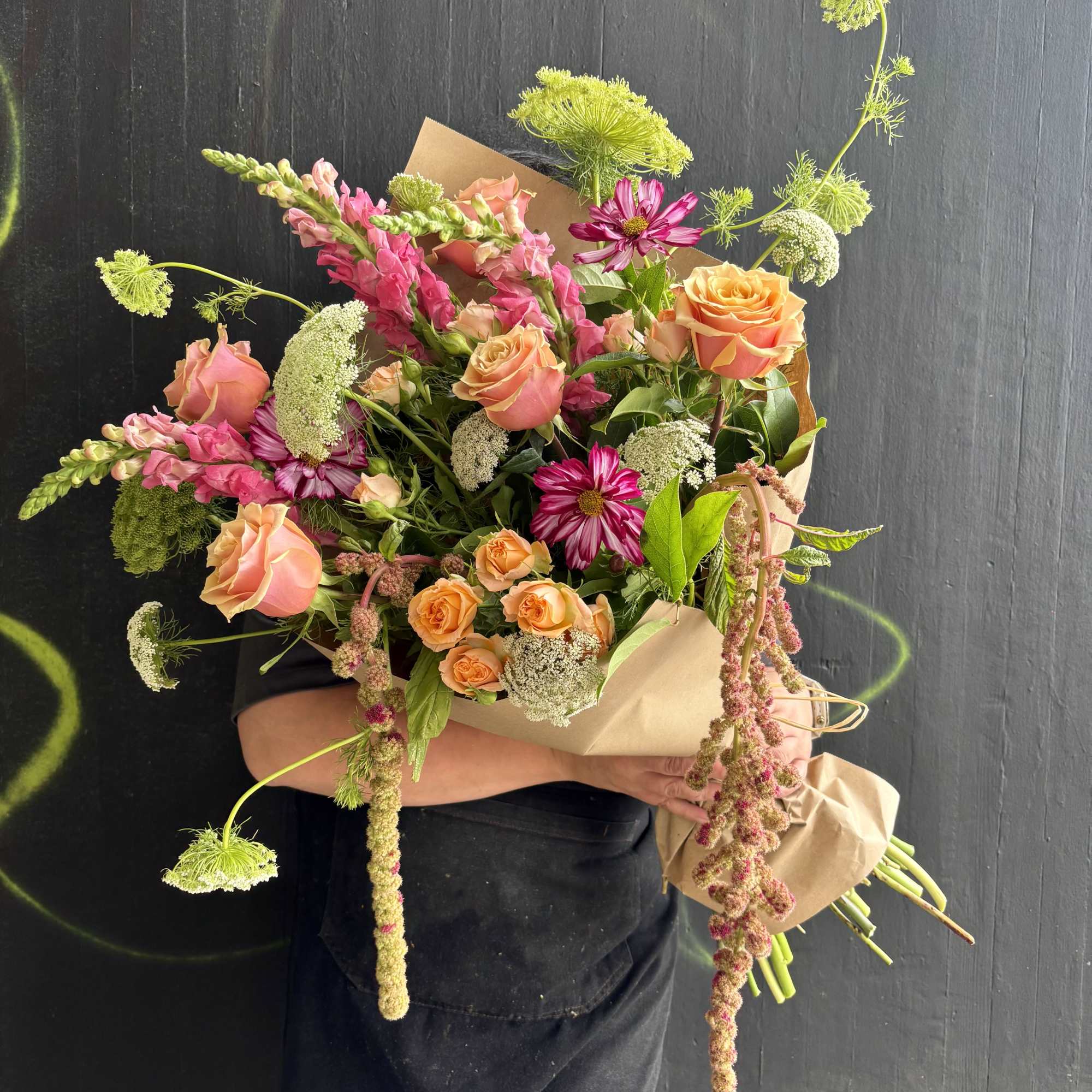 This weekly seasonal arrangement showcases queen Anne's lace, roses, and cosmos.

Our "Designs