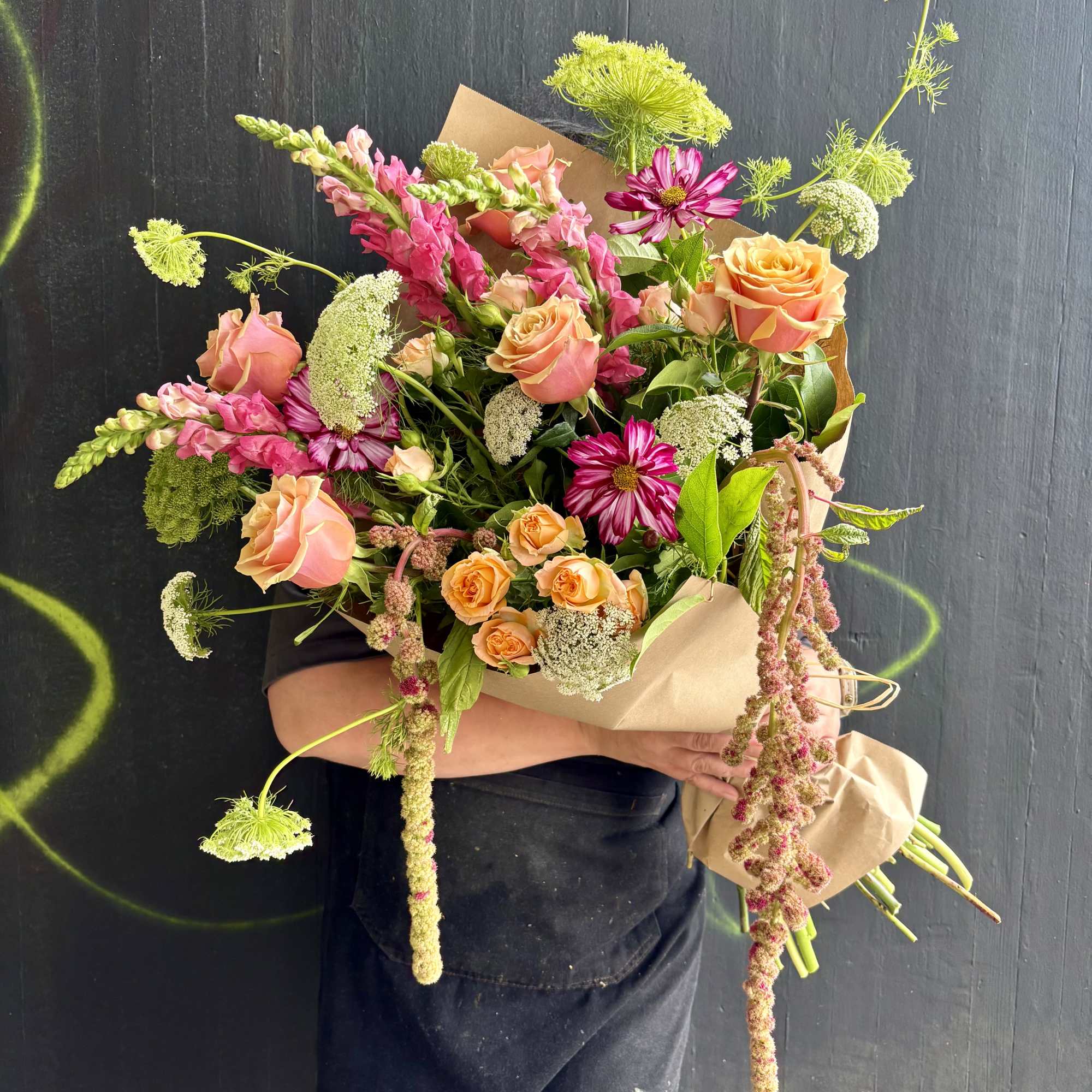 This weekly seasonal arrangement showcases queen Anne's lace, roses, and cosmos.

Our "Designs, photo 2 of 2