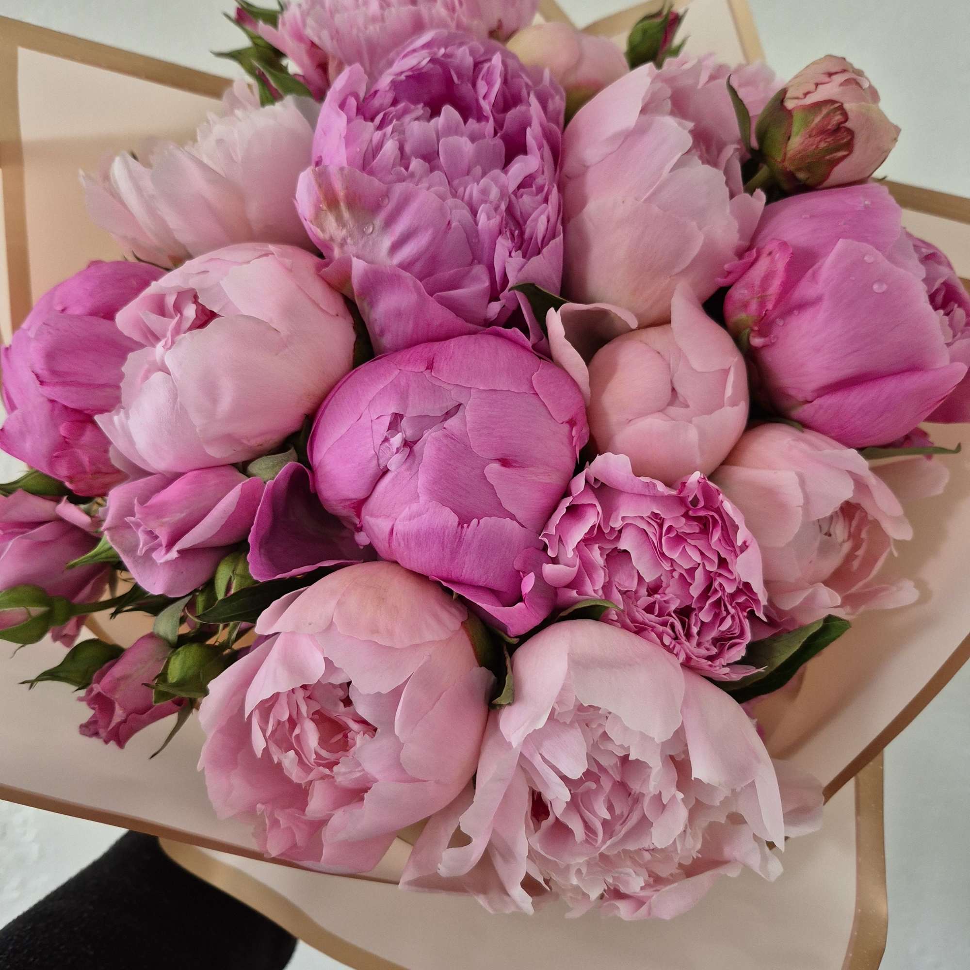 Pink peony bouquet wrapped in beige paper
