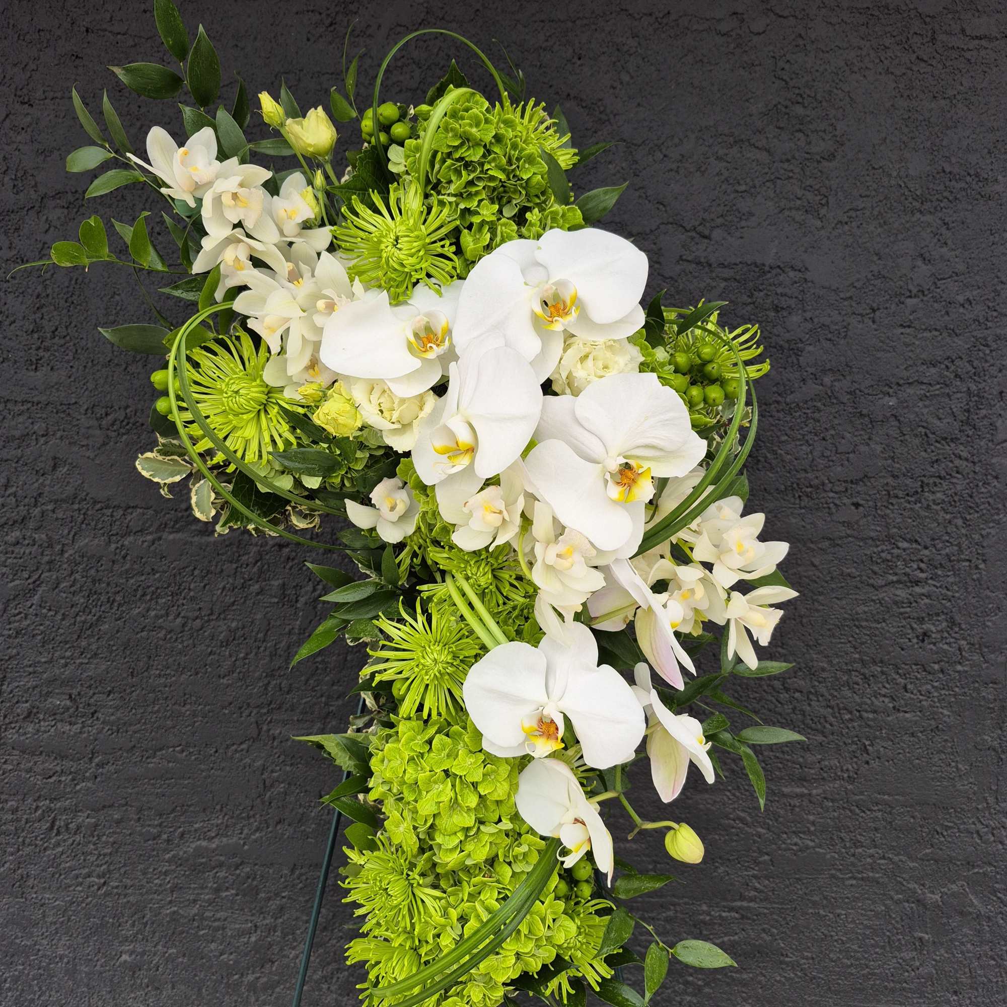 Green and white floral standing spray with orchids and chrysanthemums