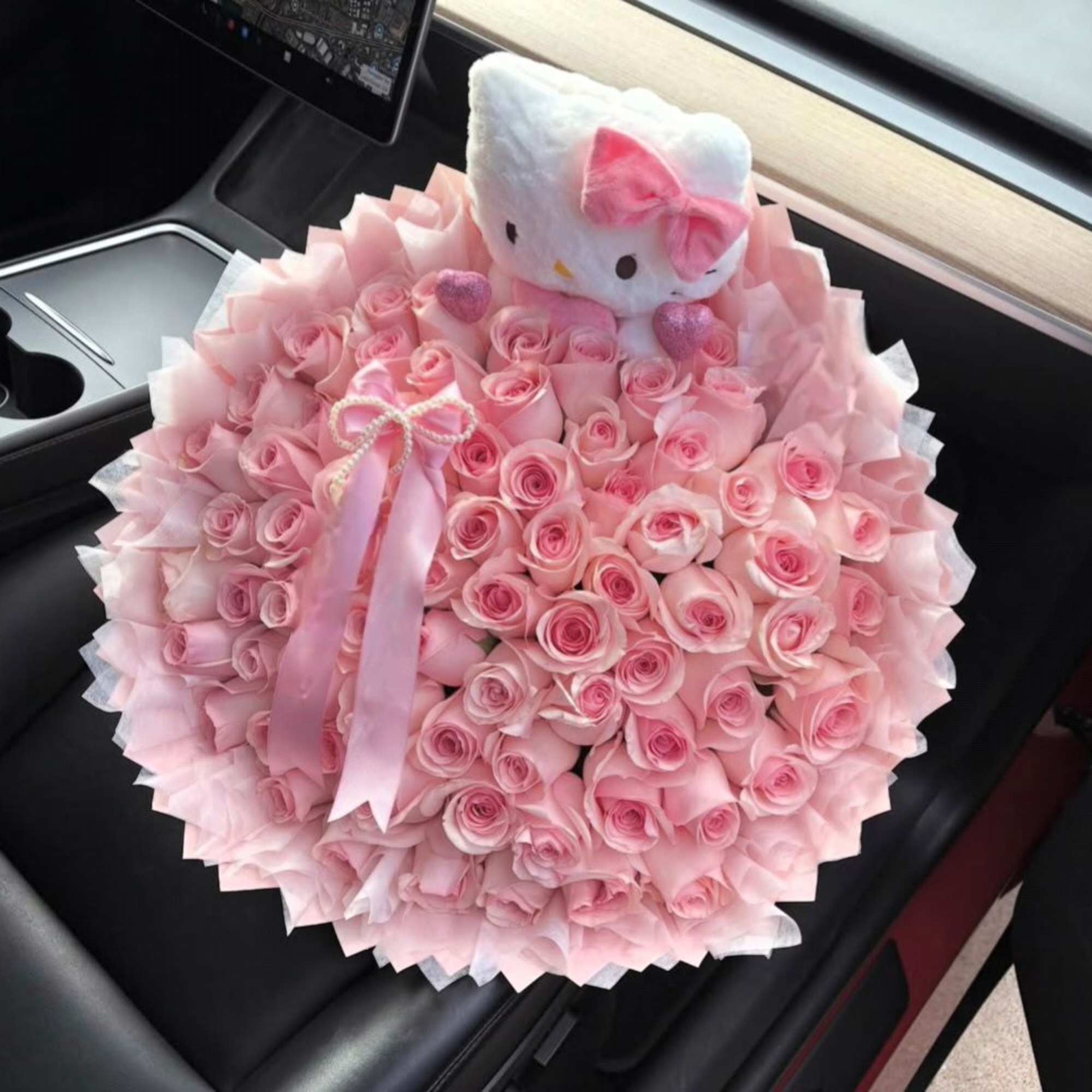 Large bouquet of pink roses with a Hello Kitty plush topper