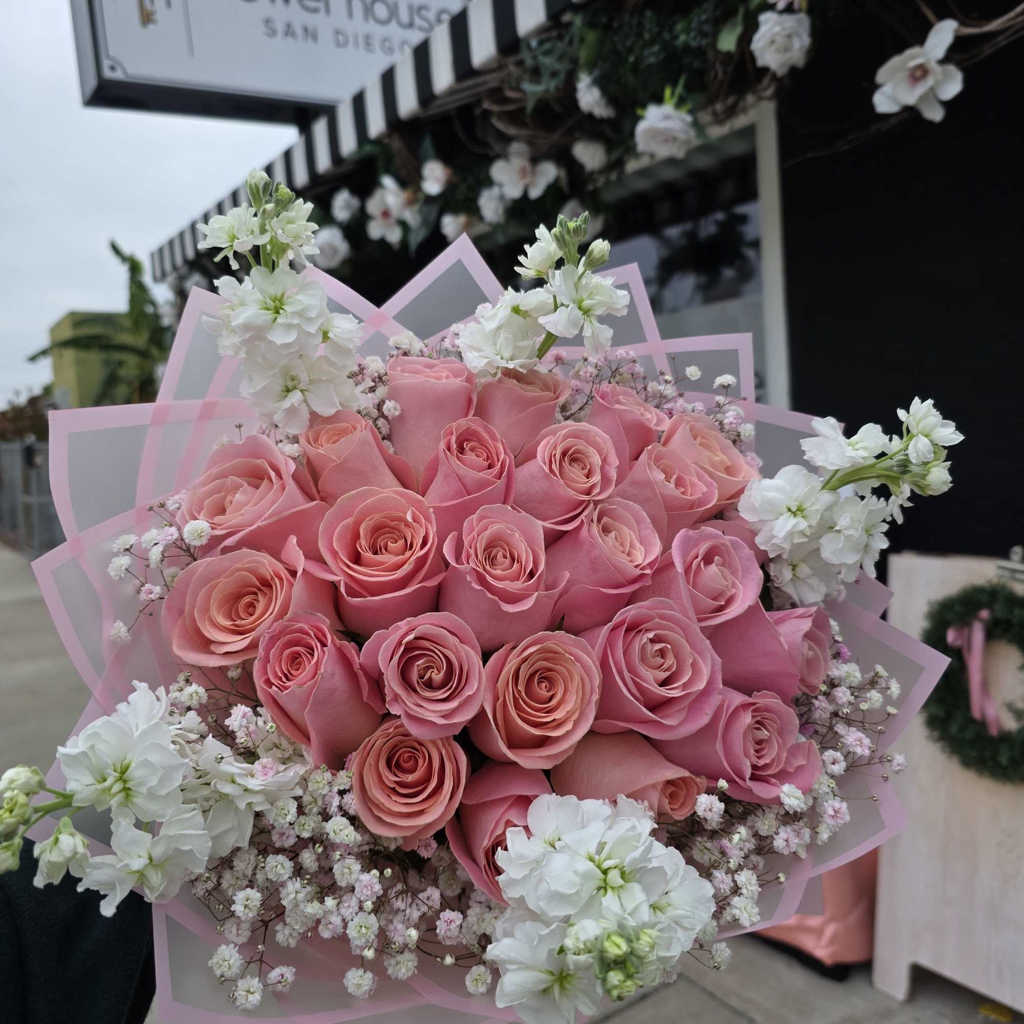 A rounded cluster of soft pink roses forms the heart of this