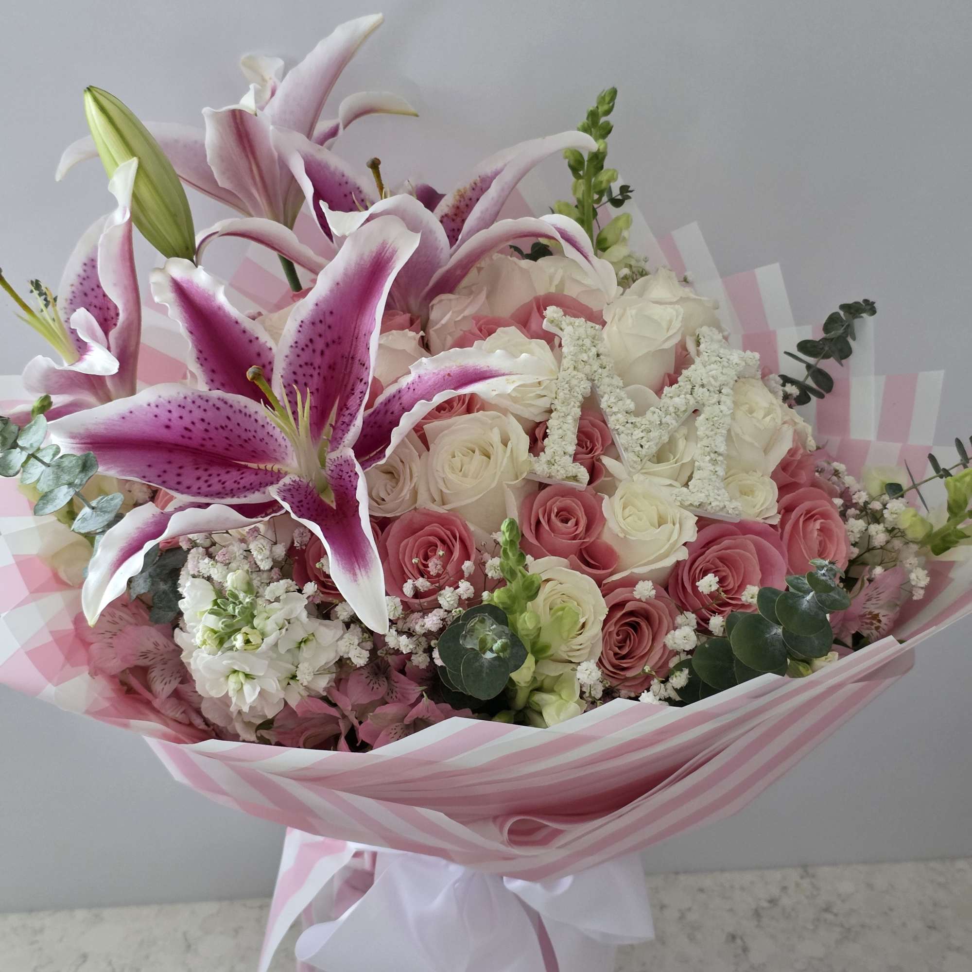 Velvety pink and ivory roses mingle with large pink-and-white oriental lilies in, photo 2 of 2