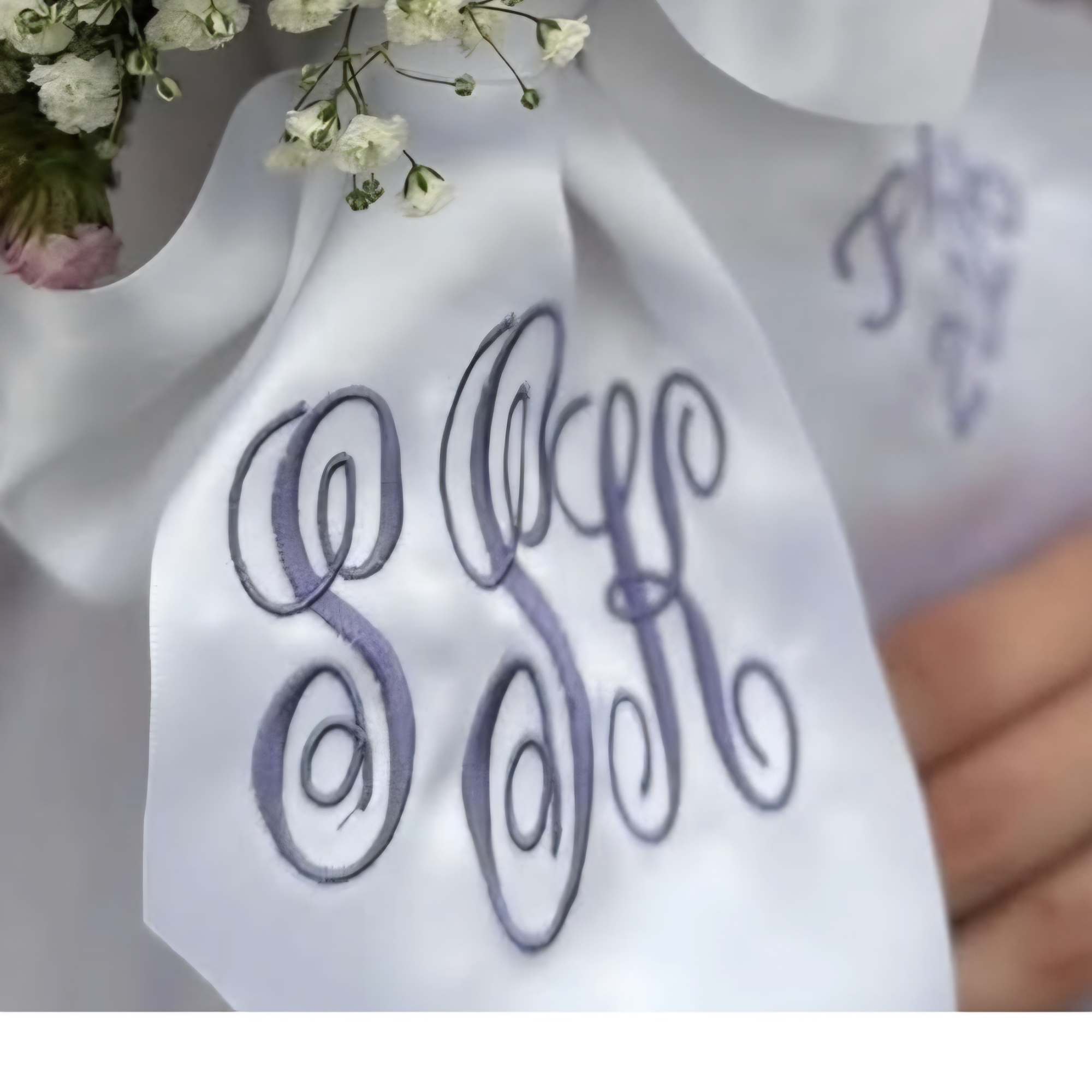 White floral bouquet with a satin ribbon tag