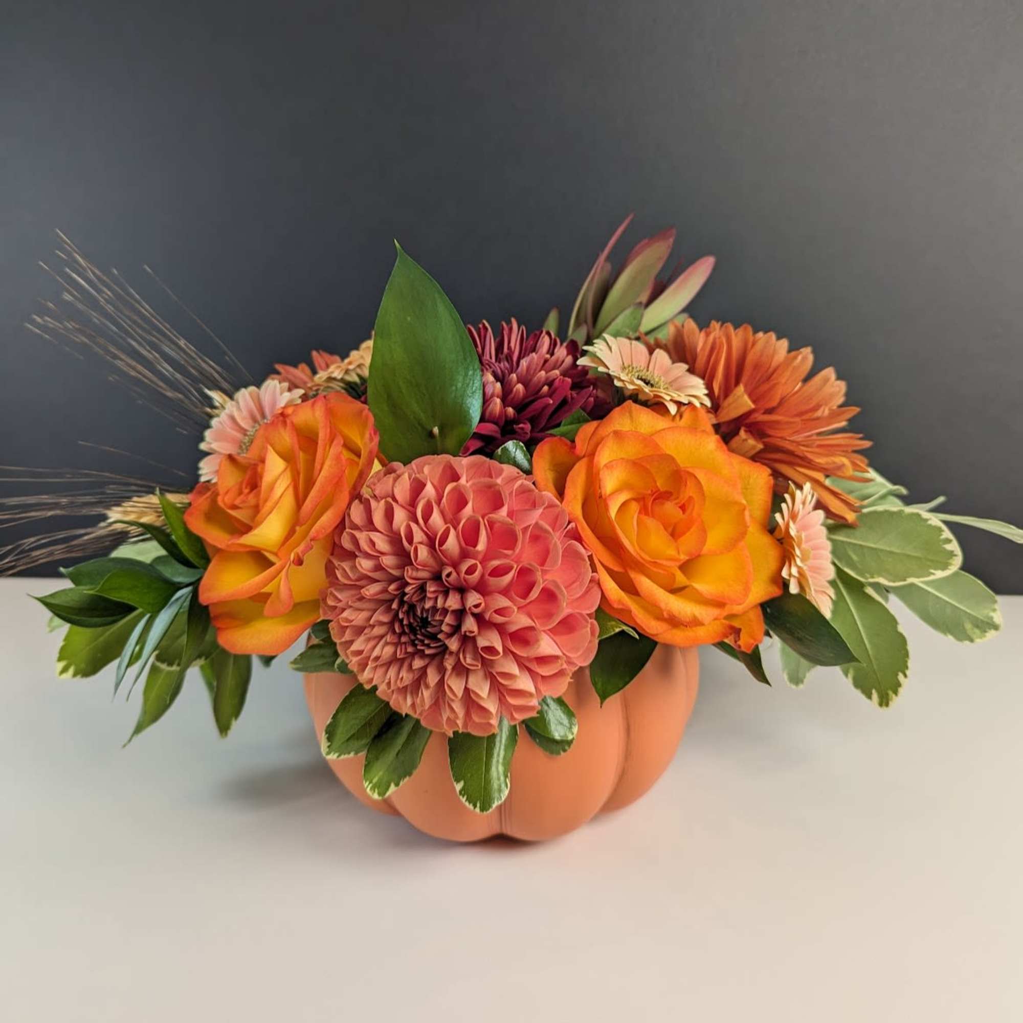 Celebrate the cozy charm of autumn with our Pumpkin Patch Blooms arrangement.