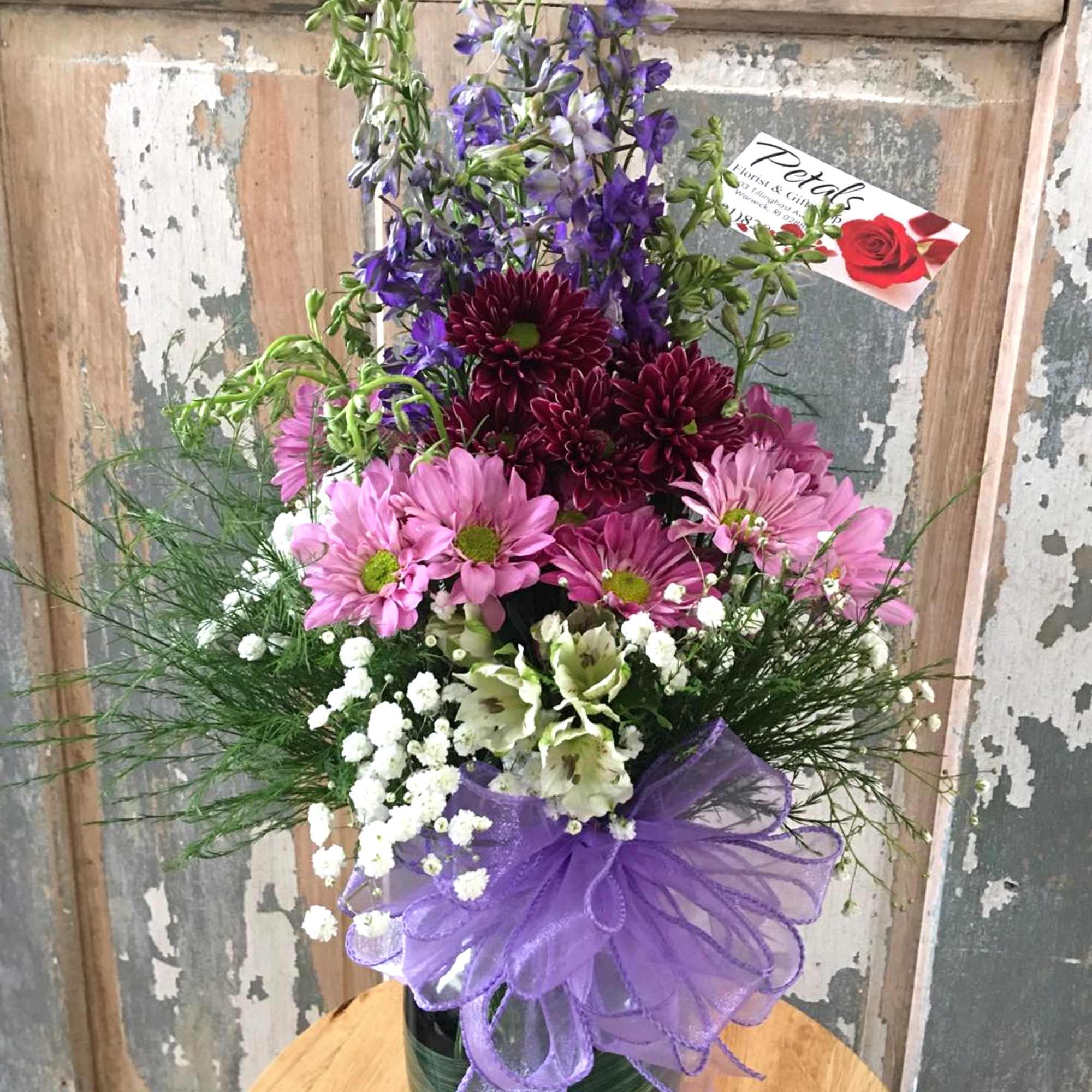 Mixed bouquet in a glass vase with purple and pink flowers