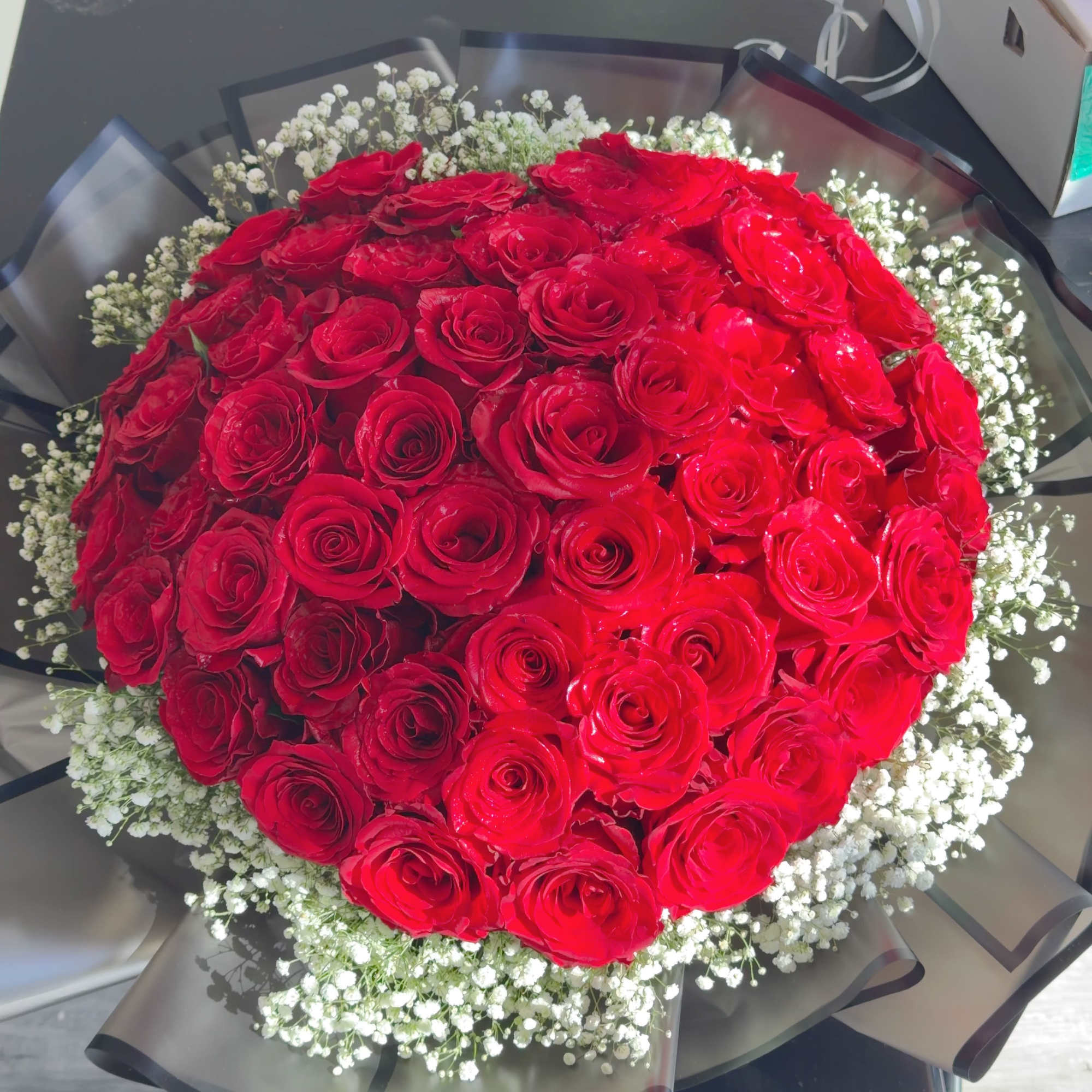 Large bouquet of red roses with white baby's breath