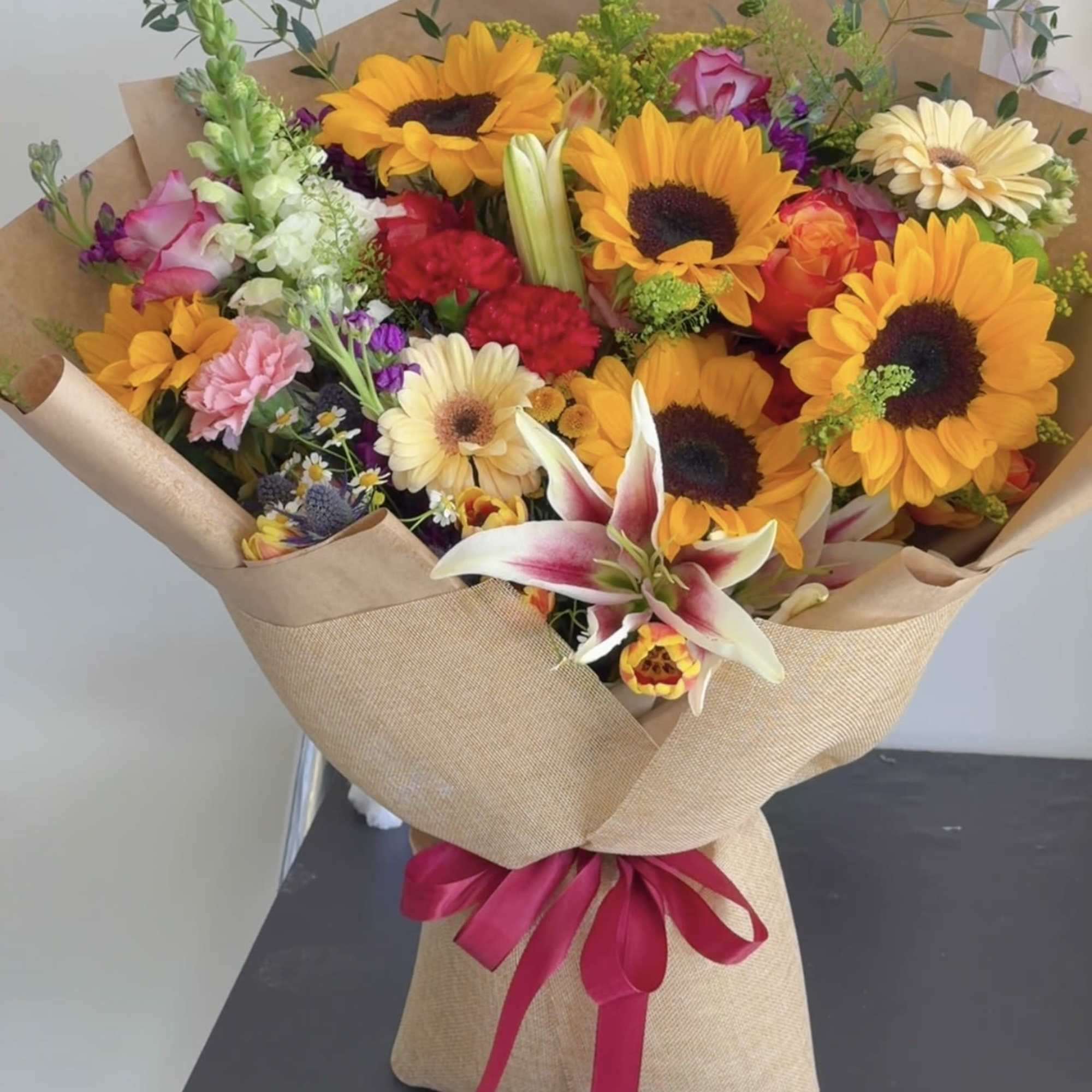 Radiant Summer Bloom is a vibrant bouquet featuring cheerful sunflowers, elegant lilies, photo 2 of 4