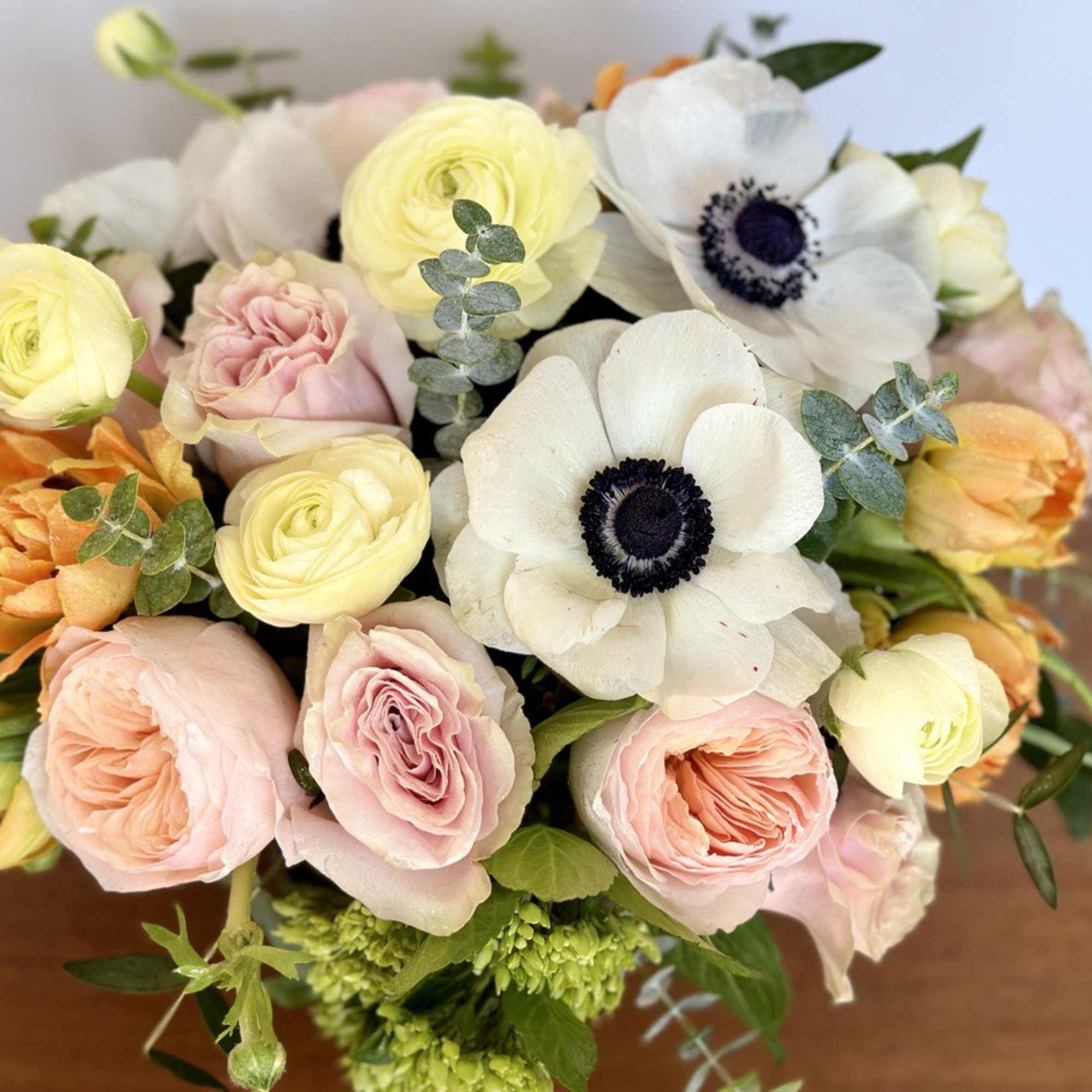 Bouquet of pale yellow, pink, orange, and white flowers