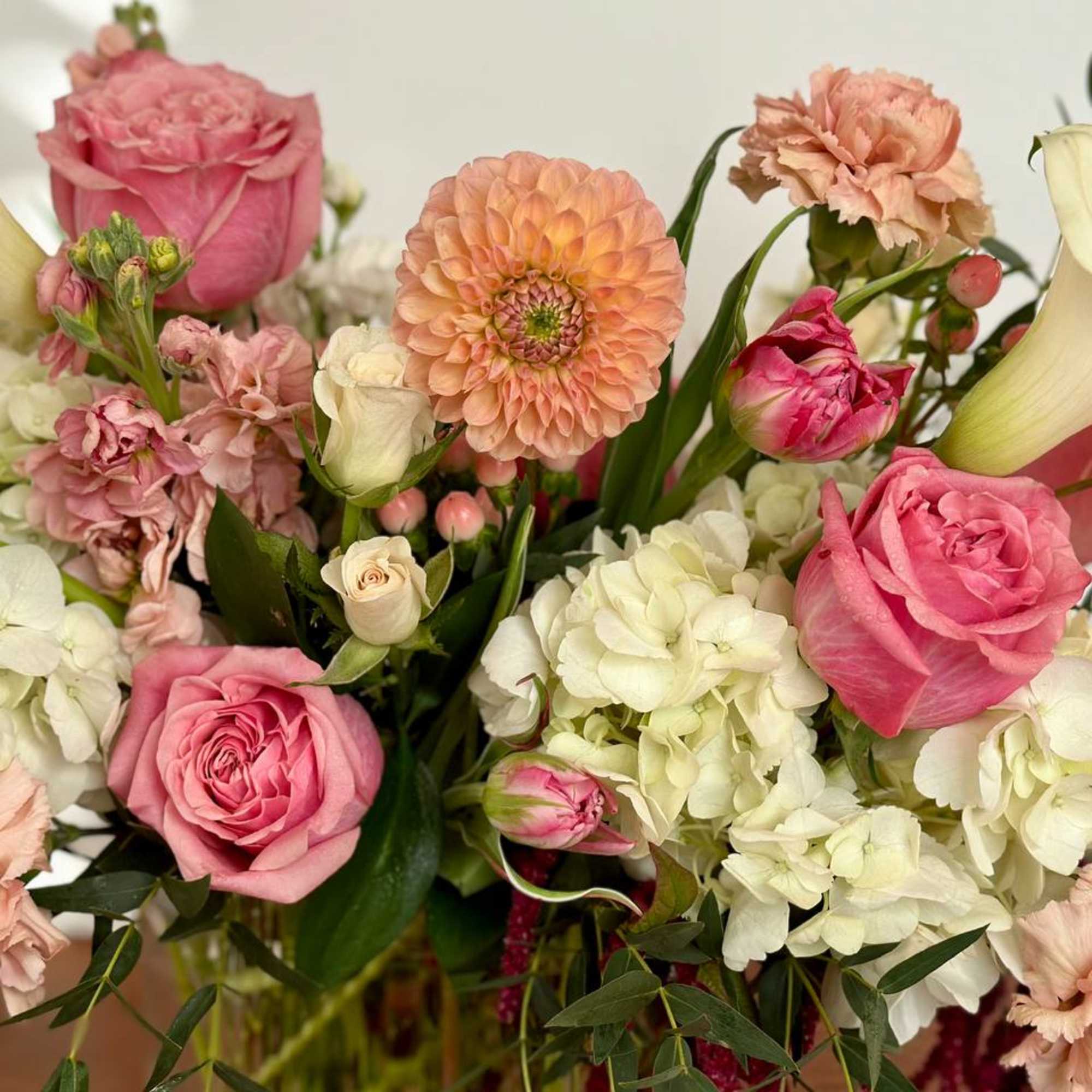Pink and peach bouquet with roses, dahlias, hydrangeas, carnations, and calla lilies