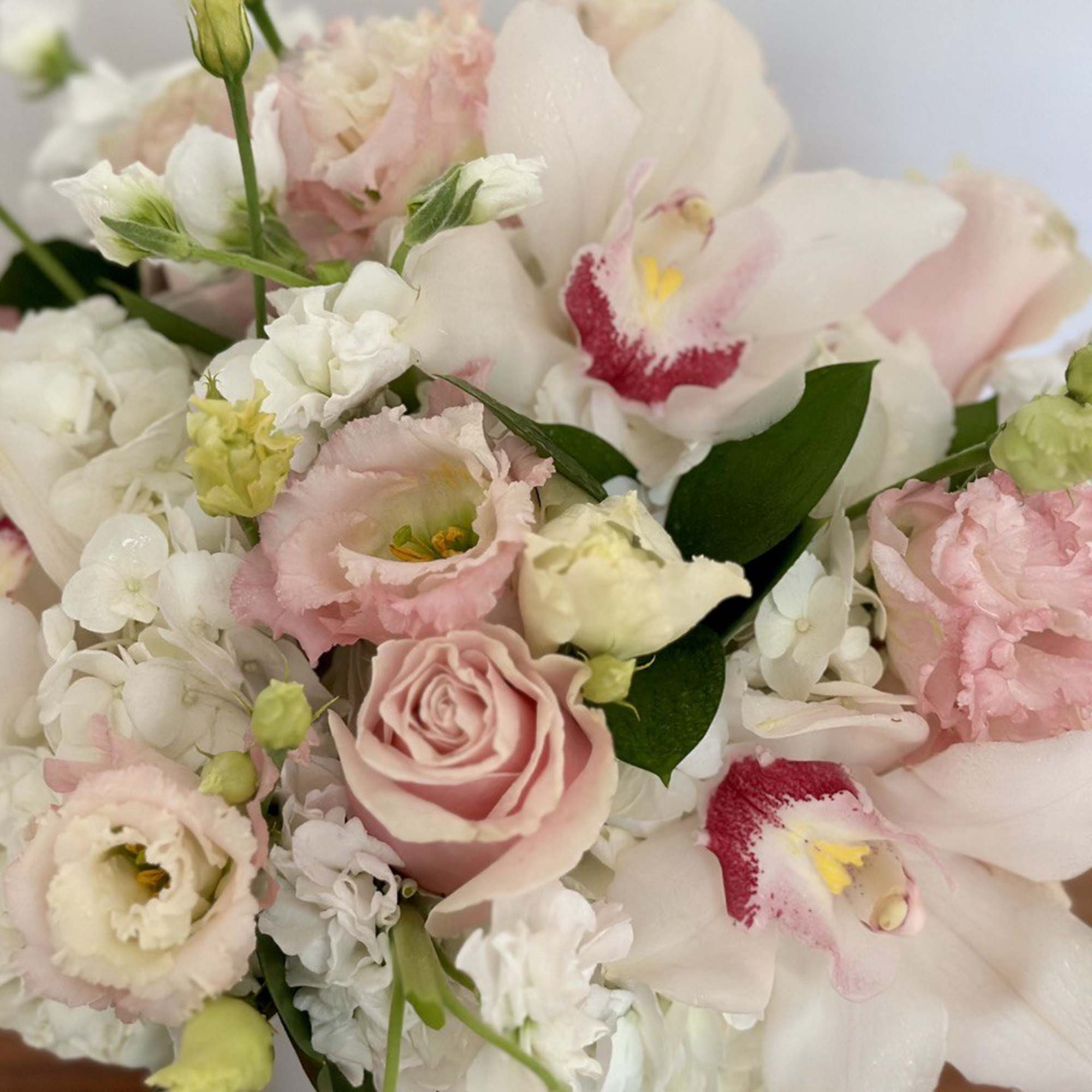 Pink and white bouquet with roses and orchids