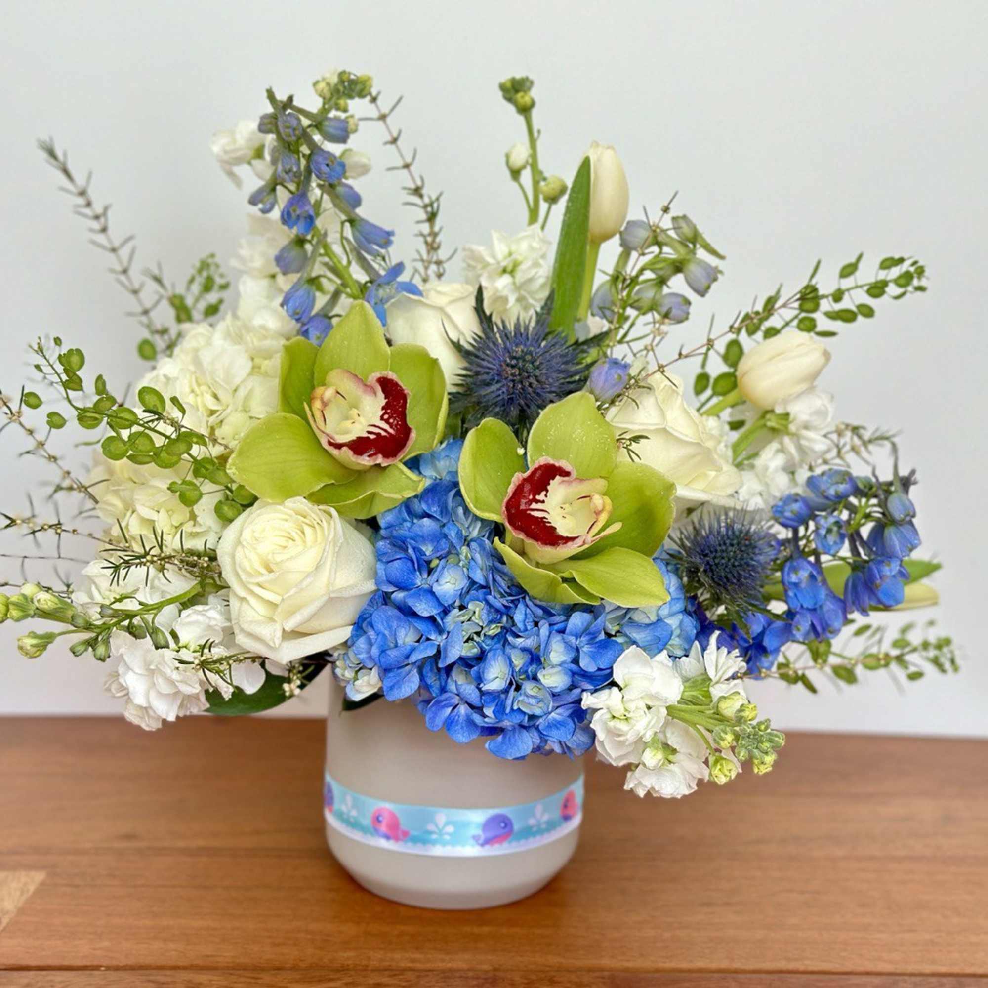 Blue and white floral arrangement in a gray vase
