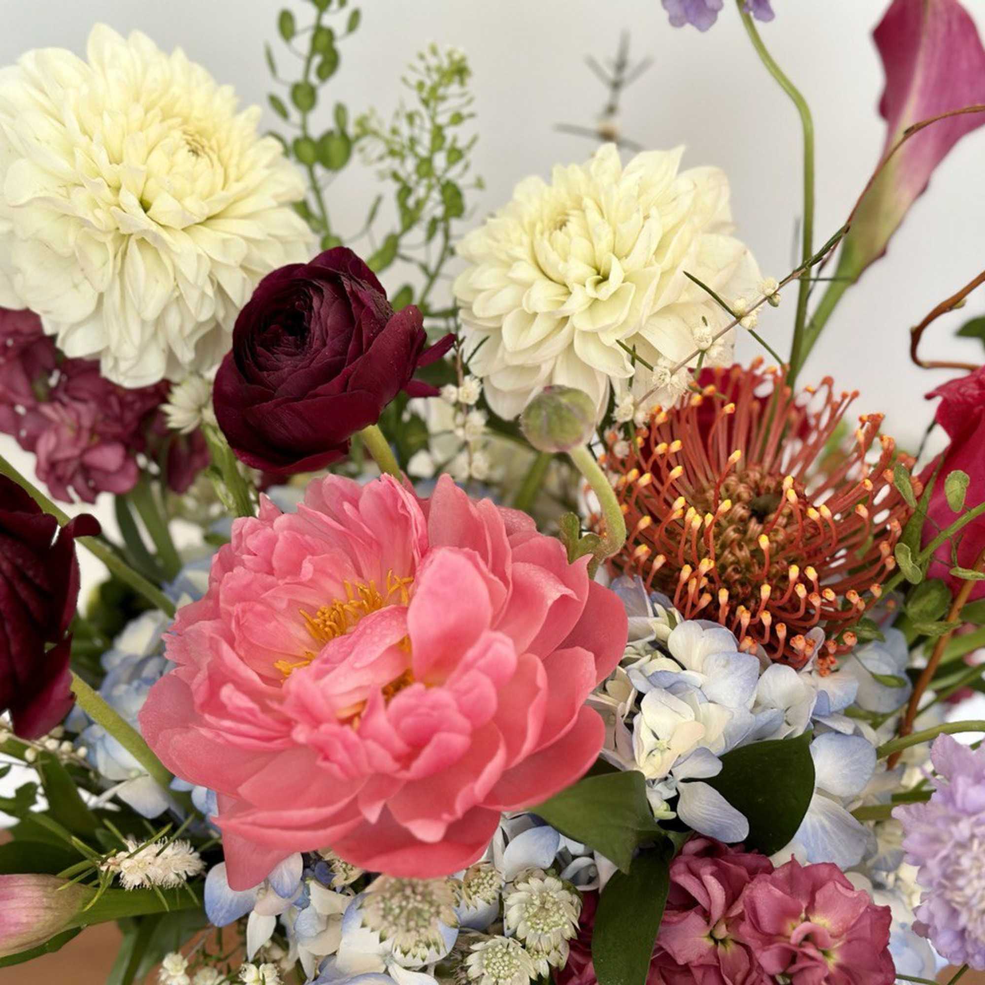 Mixed bouquet with pink, burgundy, white, and lavender flowers