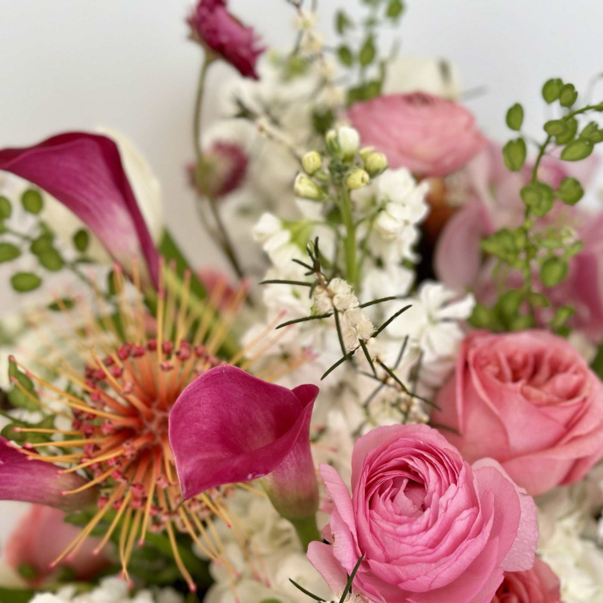 Pink and white bouquet with calla lilies, roses, and mixed blooms