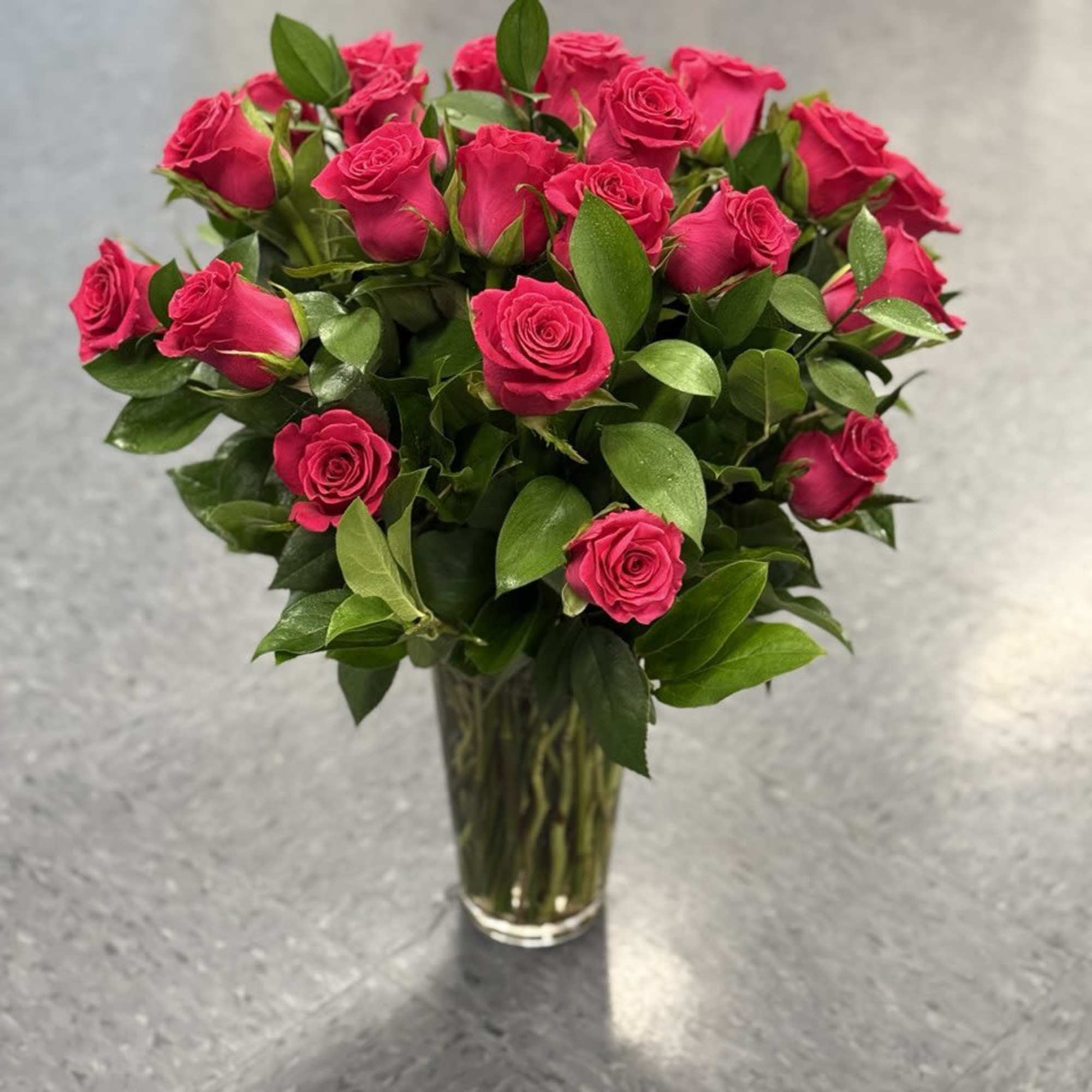 Bouquet of hot pink roses in a clear glass vase