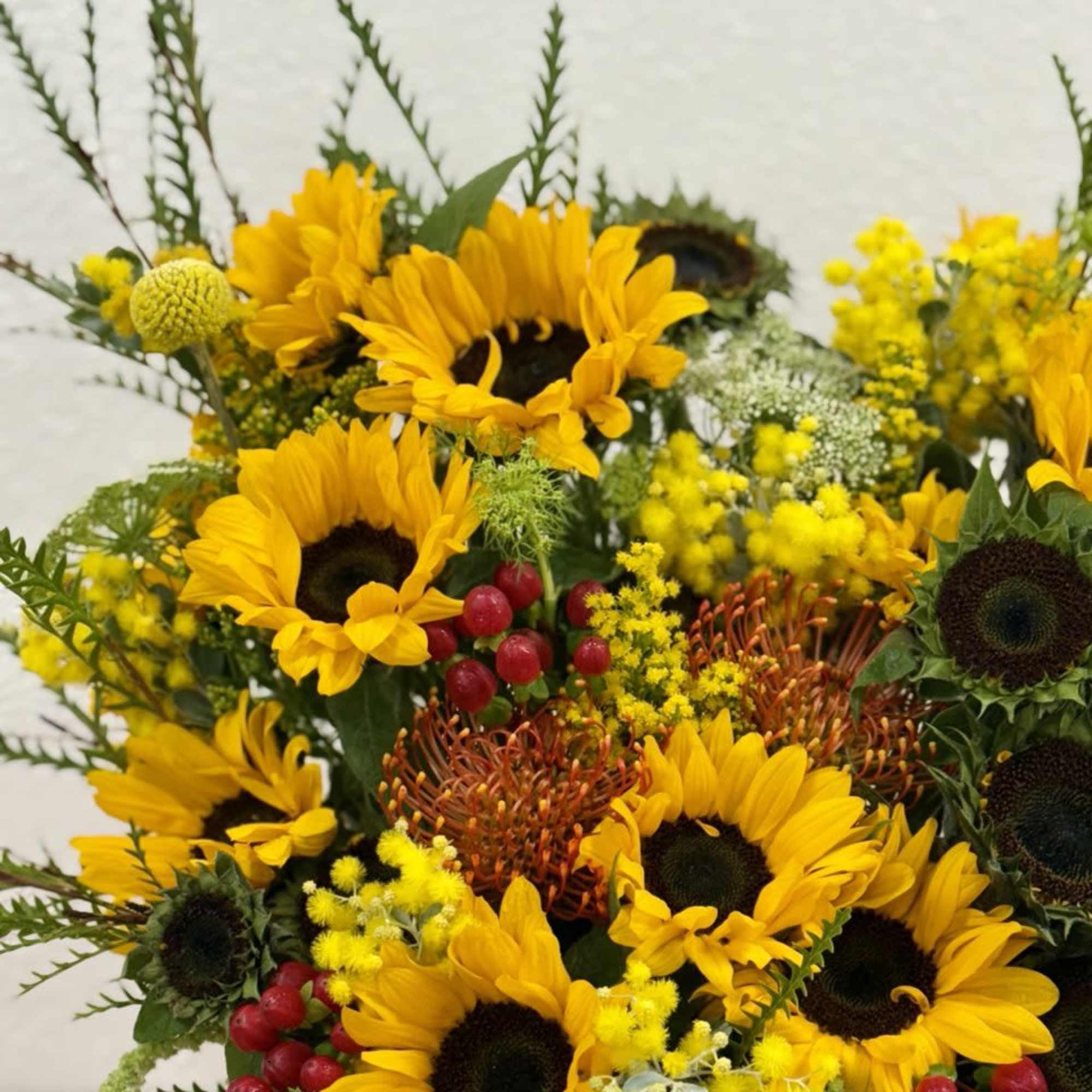 Bouquet of yellow sunflowers with red berries and mixed filler flowers, photo 3 of 4