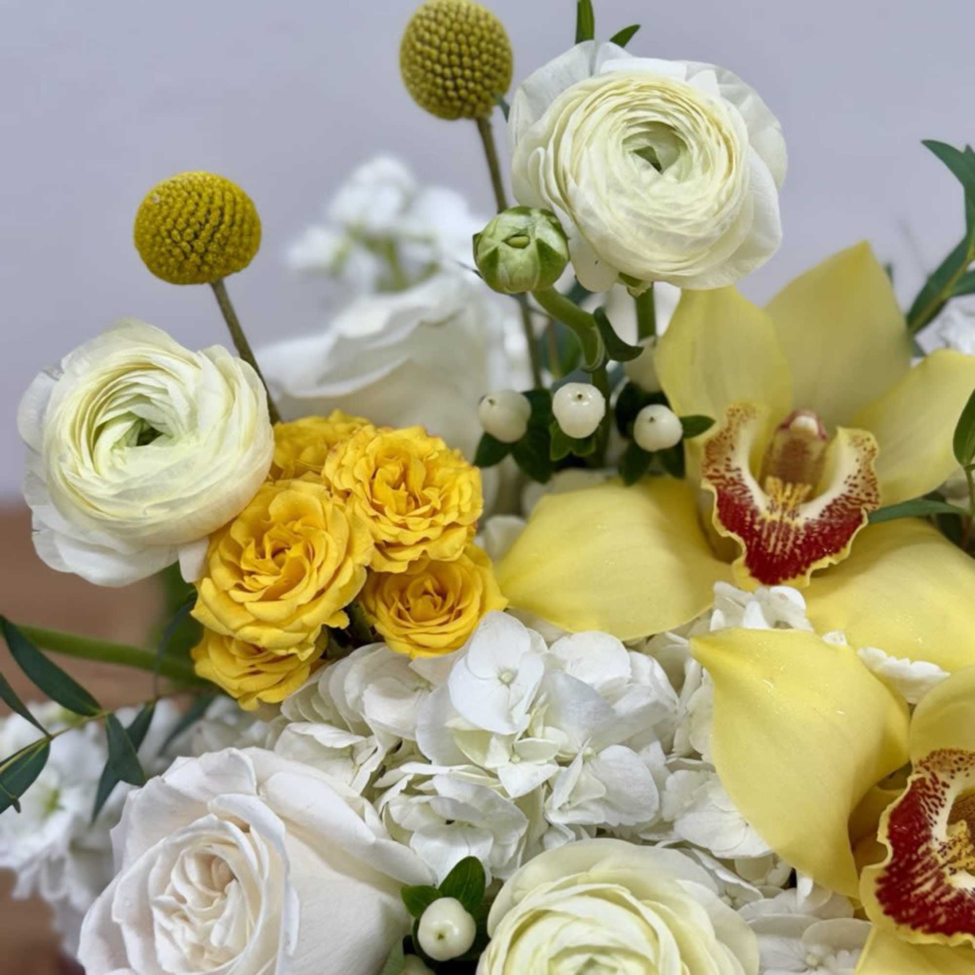 Bouquet of white and yellow flowers with orchids and hydrangea