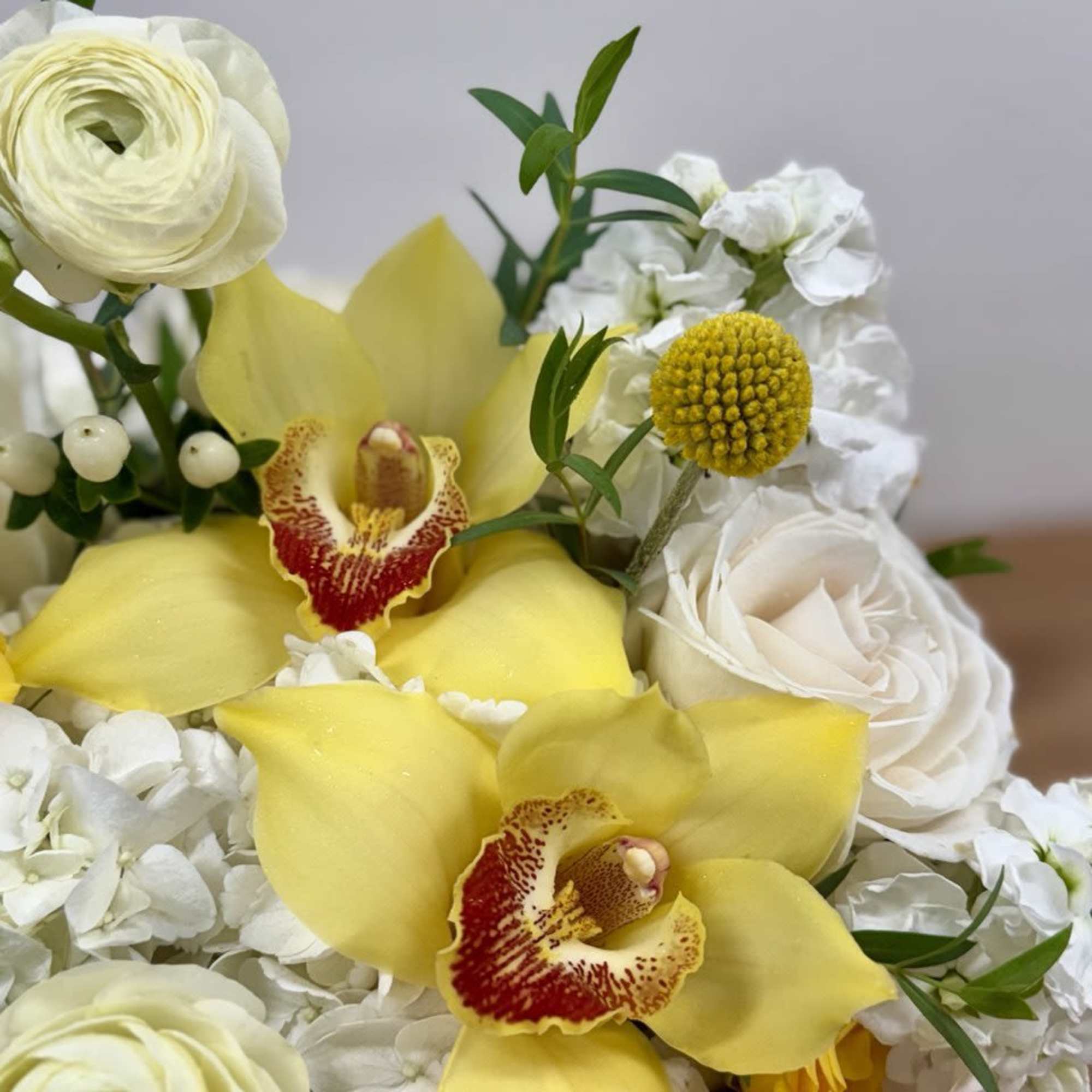 Yellow orchids and white roses in a mixed bouquet