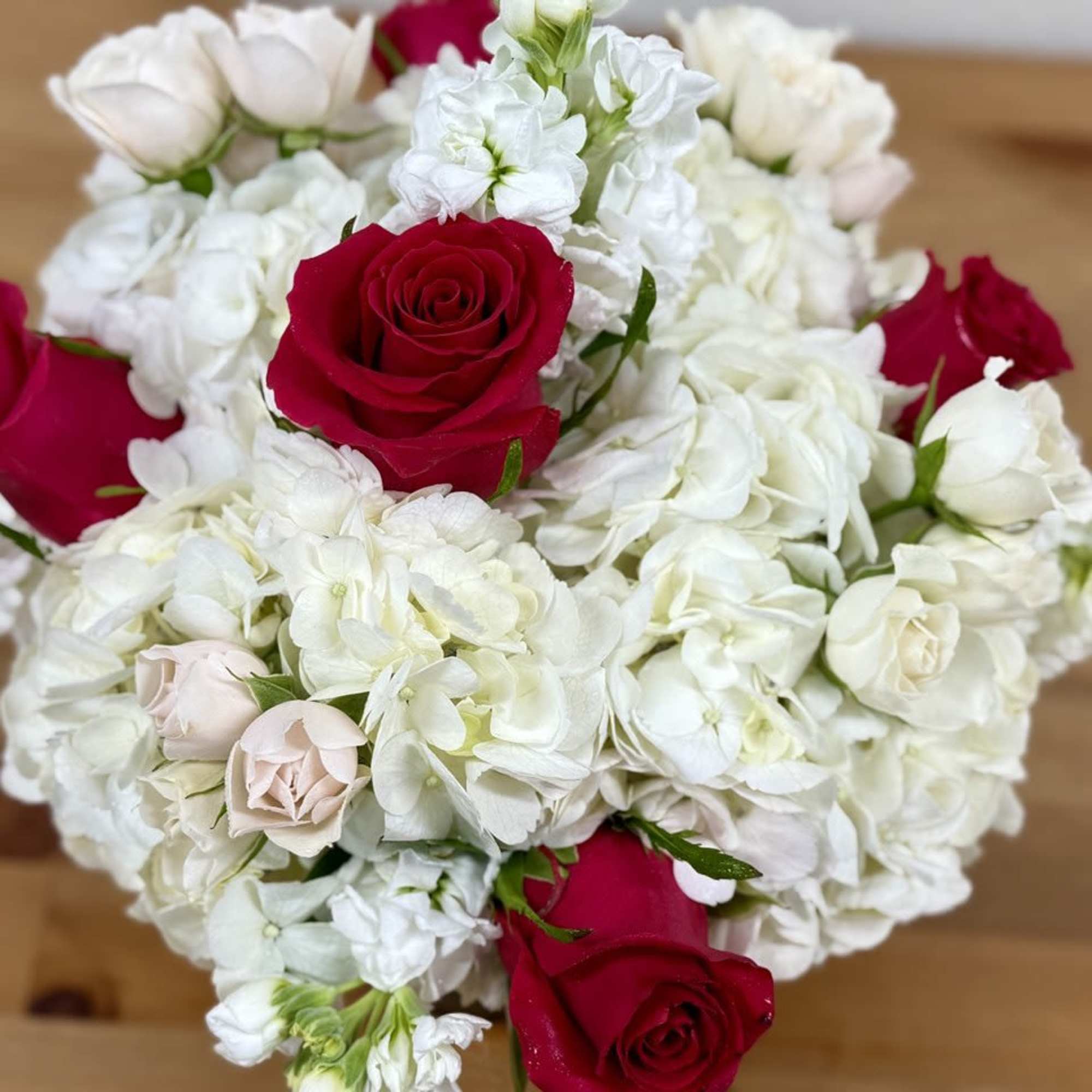 Bouquet of red and pale pink roses with white hydrangeas