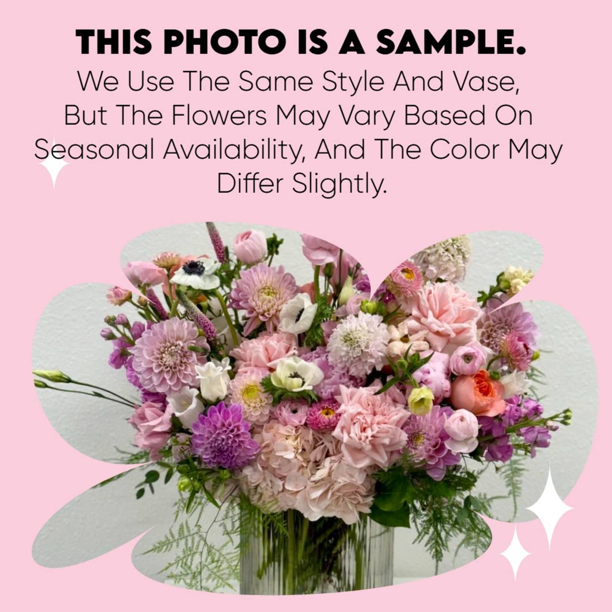 Pink and purple mixed flower arrangement in a clear vase