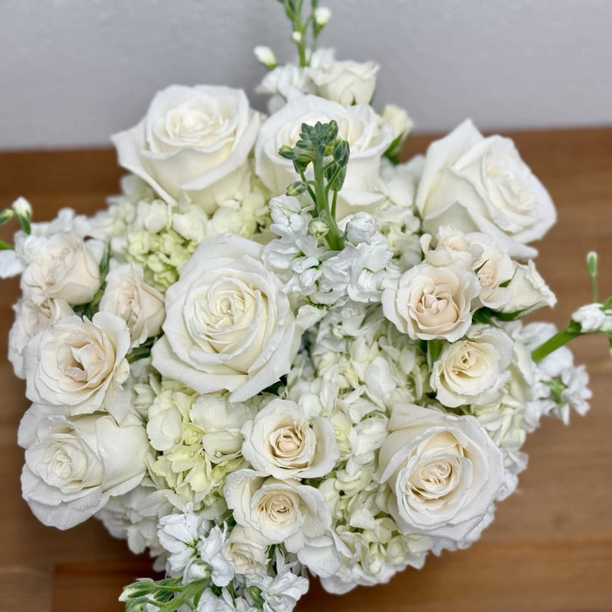 White rose bouquet with small white filler flowers