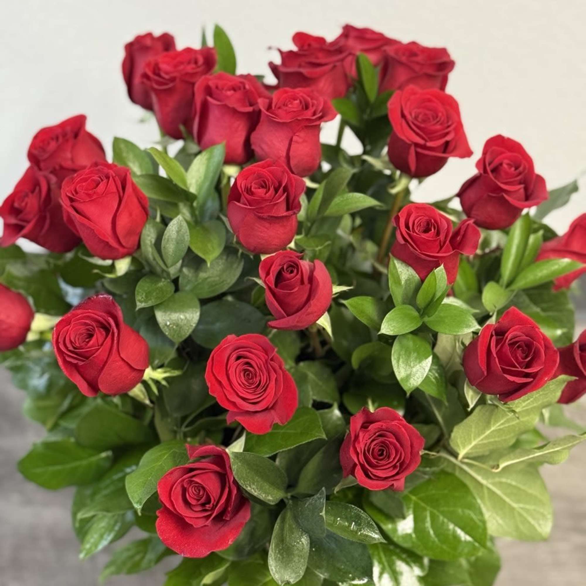 Bouquet of red roses with glossy green foliage