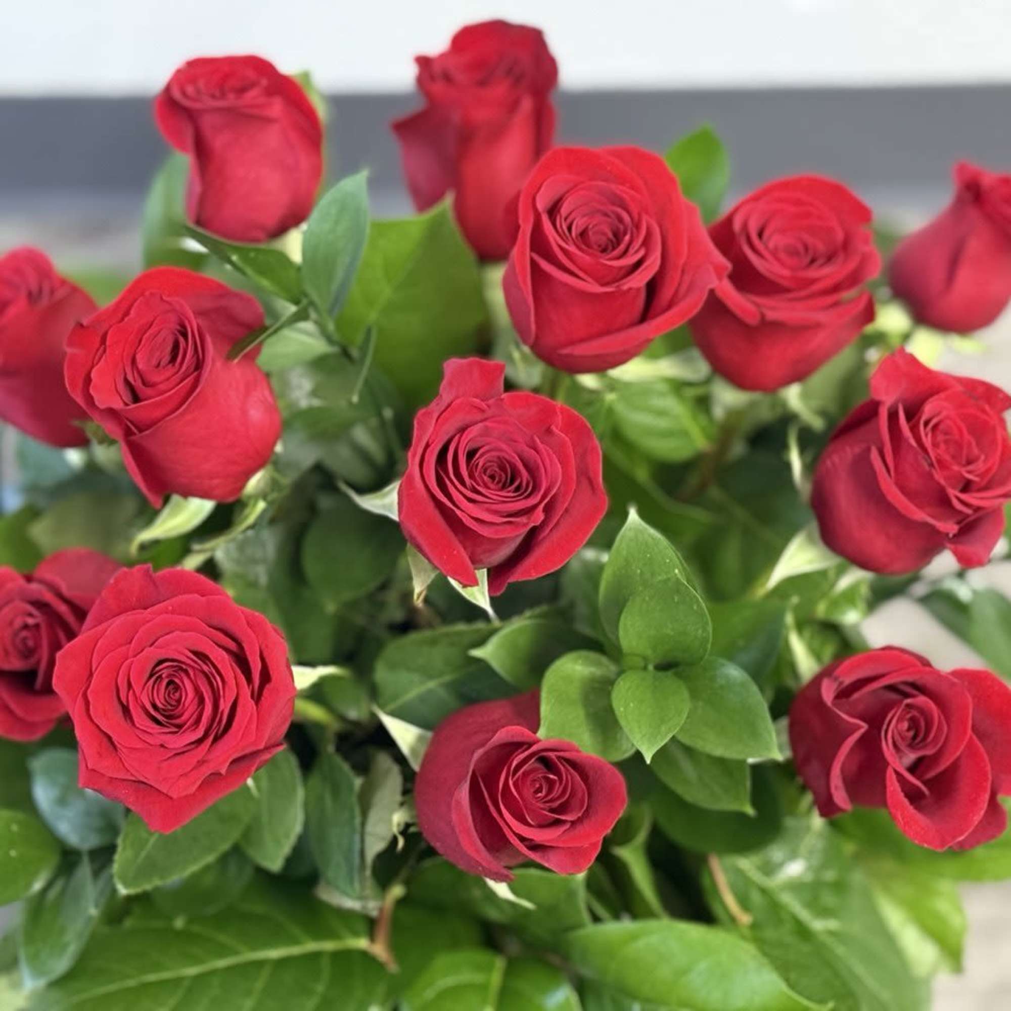 Bouquet of red roses with green foliage