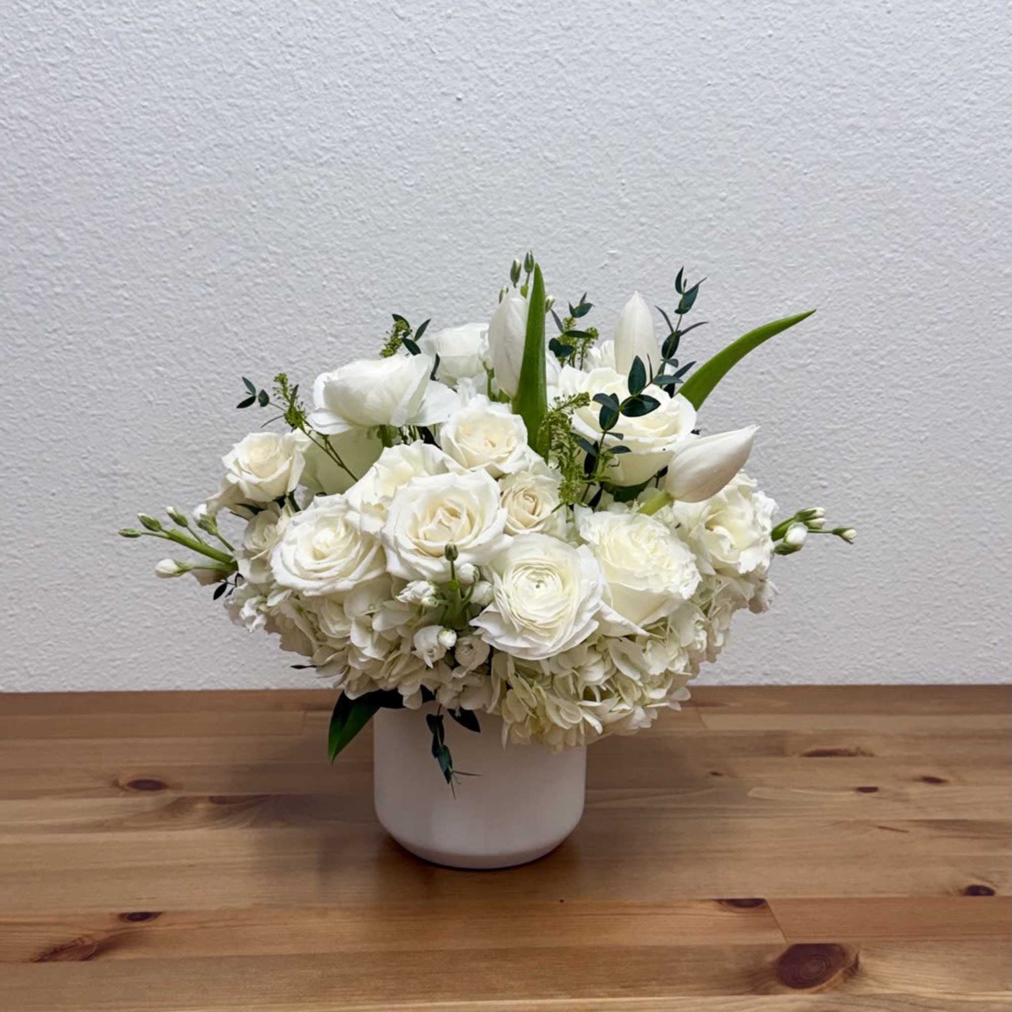 White floral arrangement in a white vase