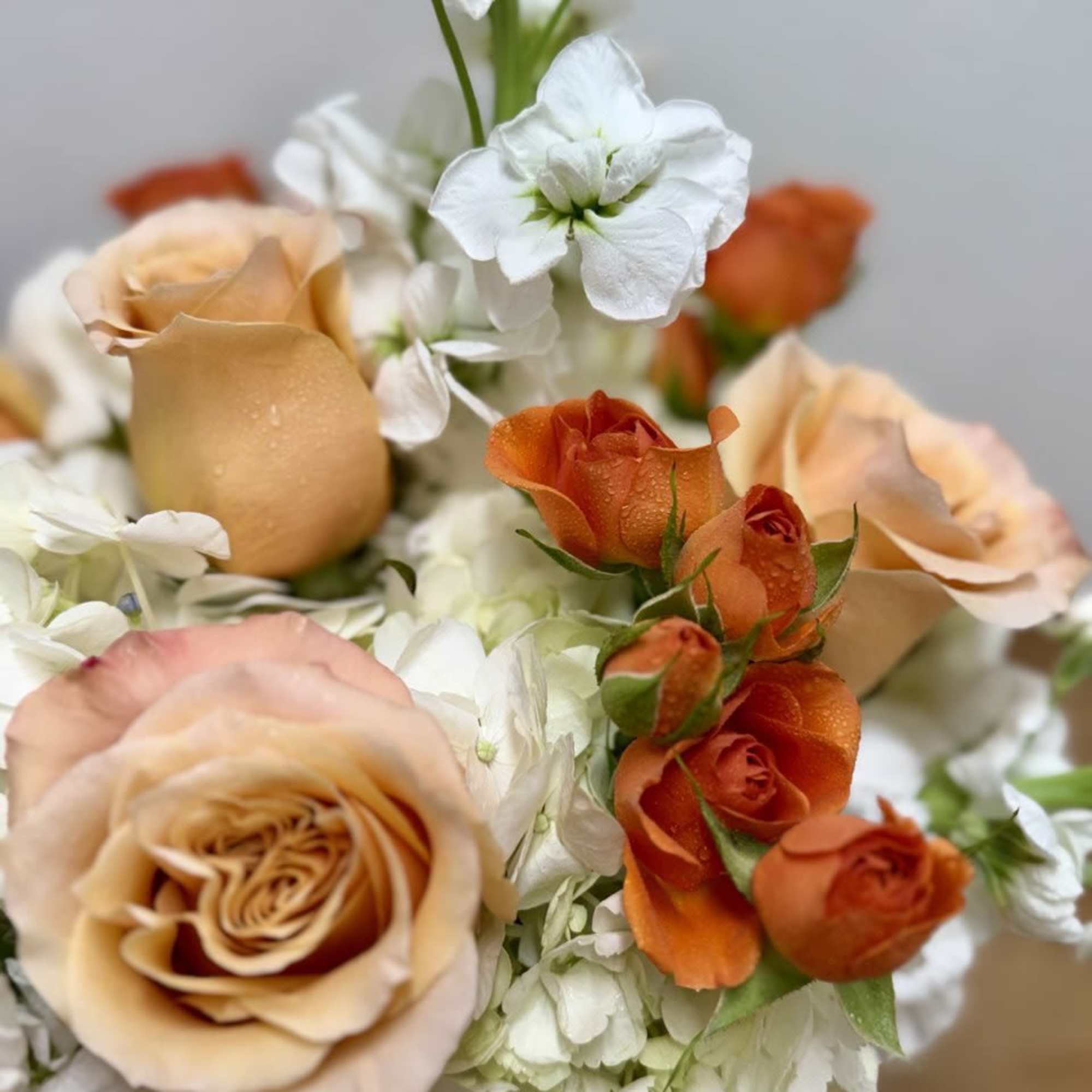 Bouquet of peach and orange roses with white flowers, photo 2 of 3
