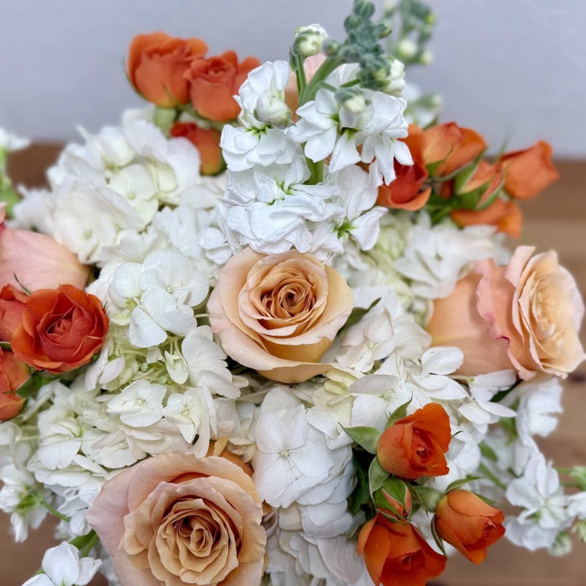 Bouquet of peach and orange roses with white flowers, photo 3 of 3