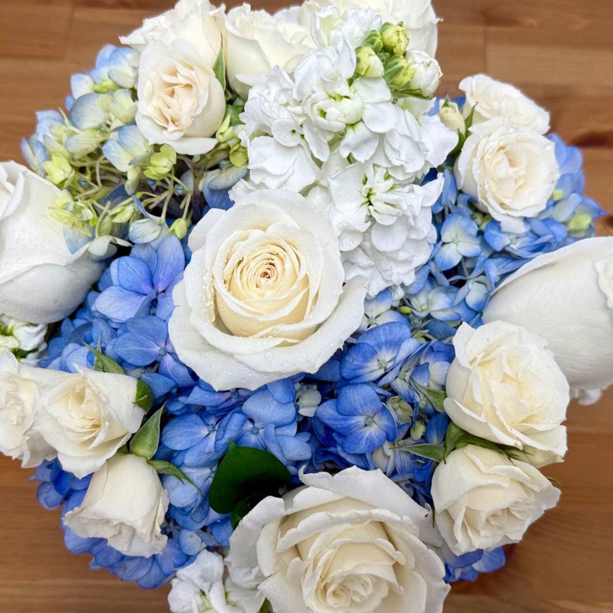 An elegant arrangement of white and blue flowers, artfully designed with premium, photo 2 of 3