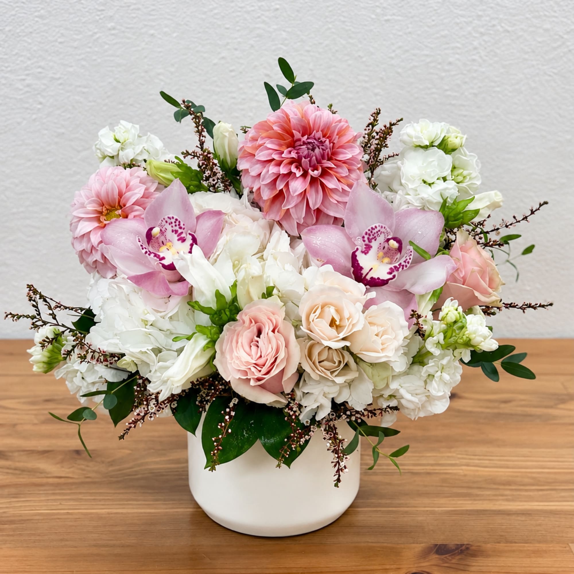 Pink and white floral arrangement in a white vase