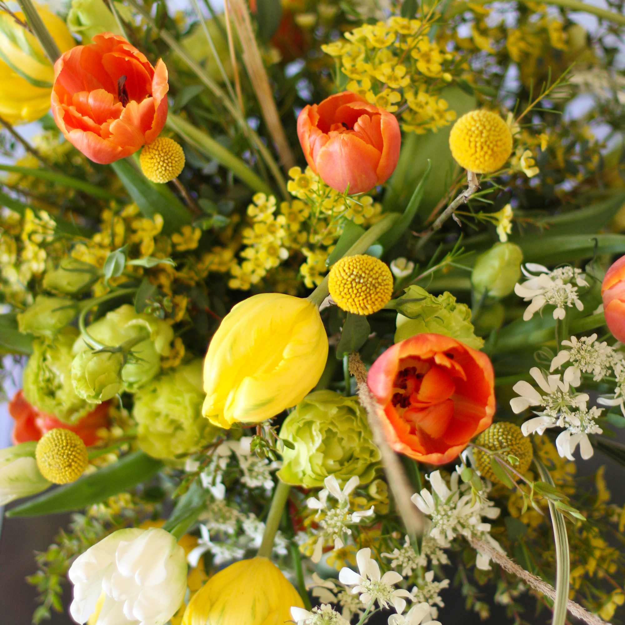 A cheerful Orange, yellow and Ivory Tulip combination handtie bouquet. This arrangement, photo 4 of 4