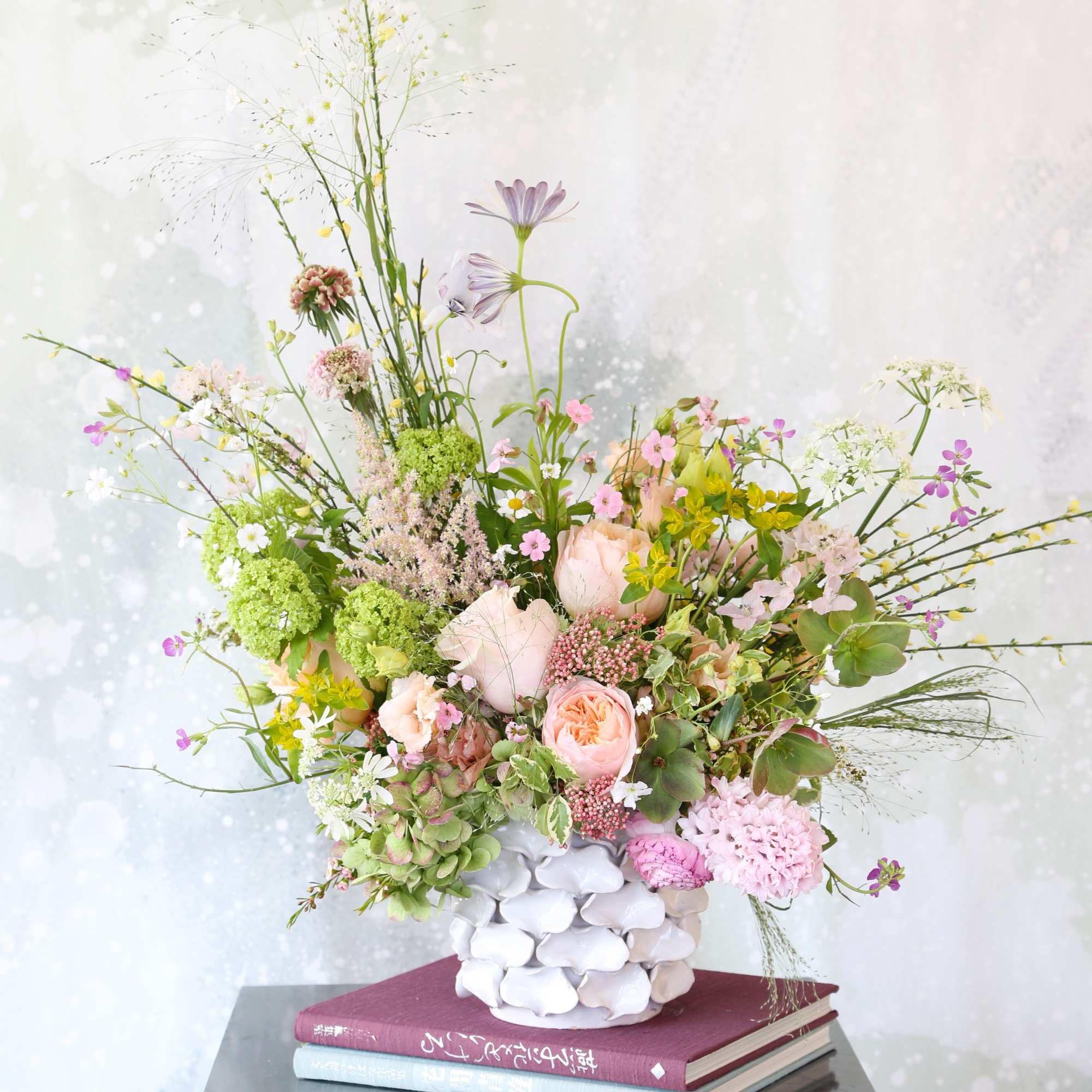 This arrangement creates with fragrant garden rose, Hyacinth, hydrangea, hellebore and seasonal