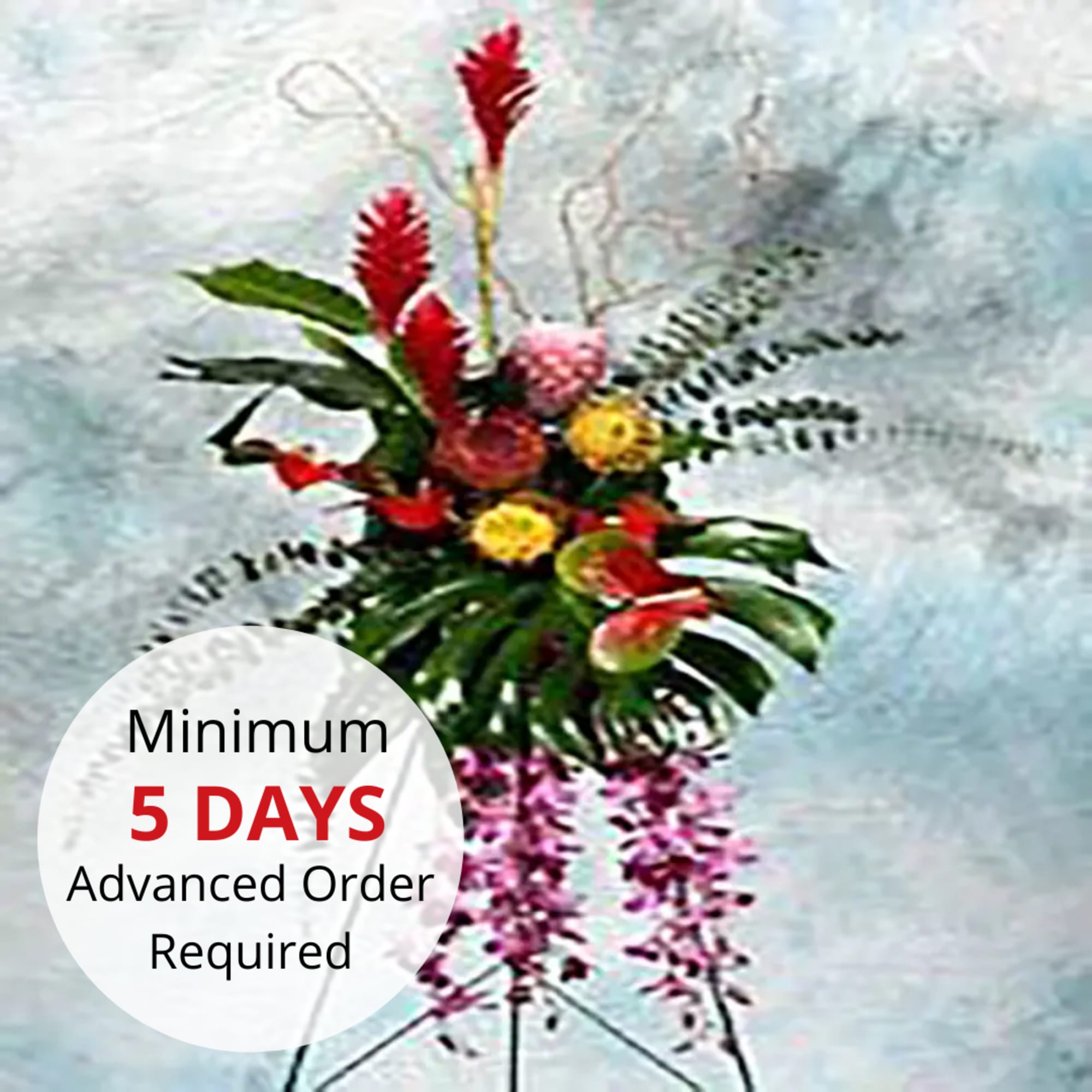 Tall tropical standing flower arrangement with red, yellow, and purple blooms on a metal tripod stand.
