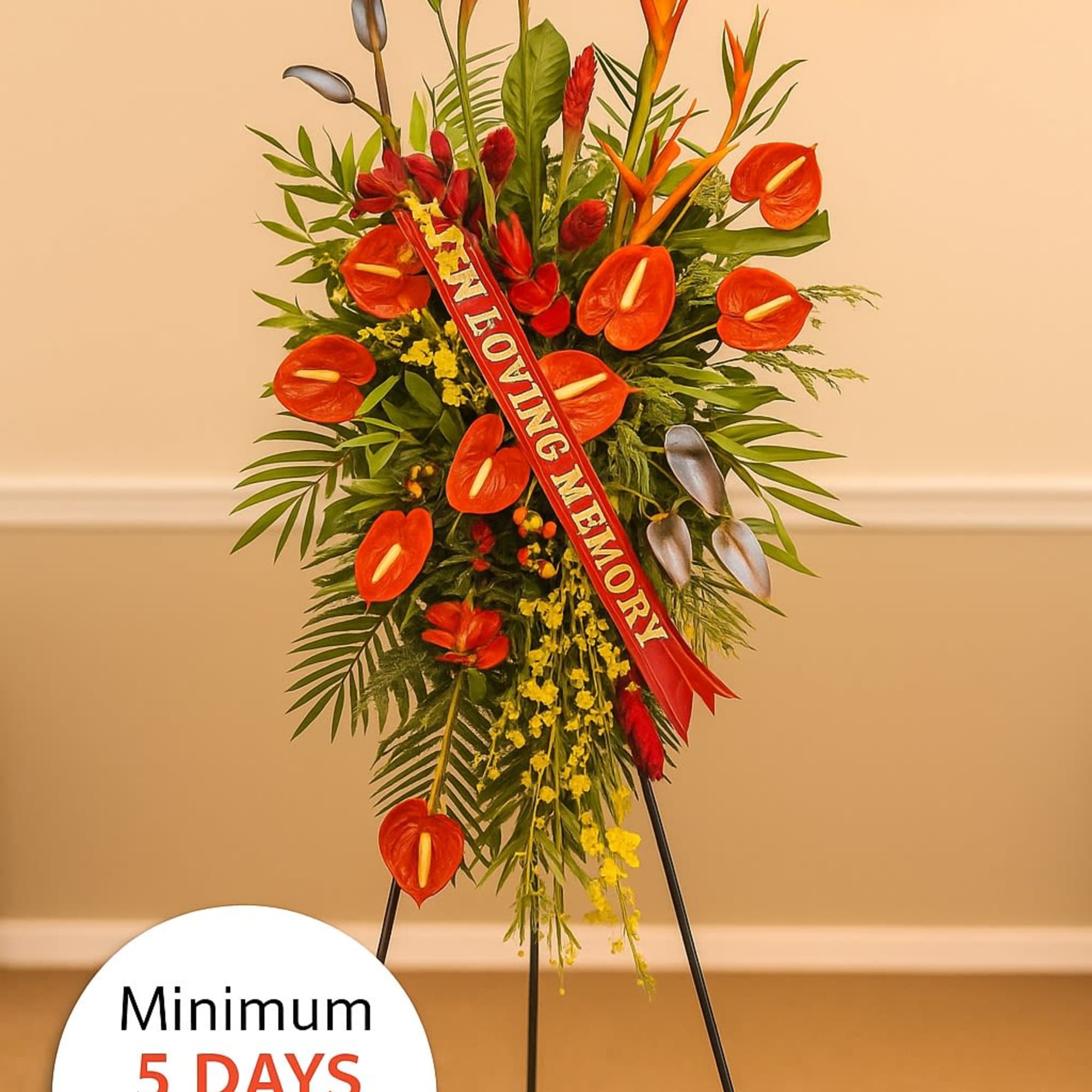 Tall tropical sympathy standing spray with red-orange flowers on an easel