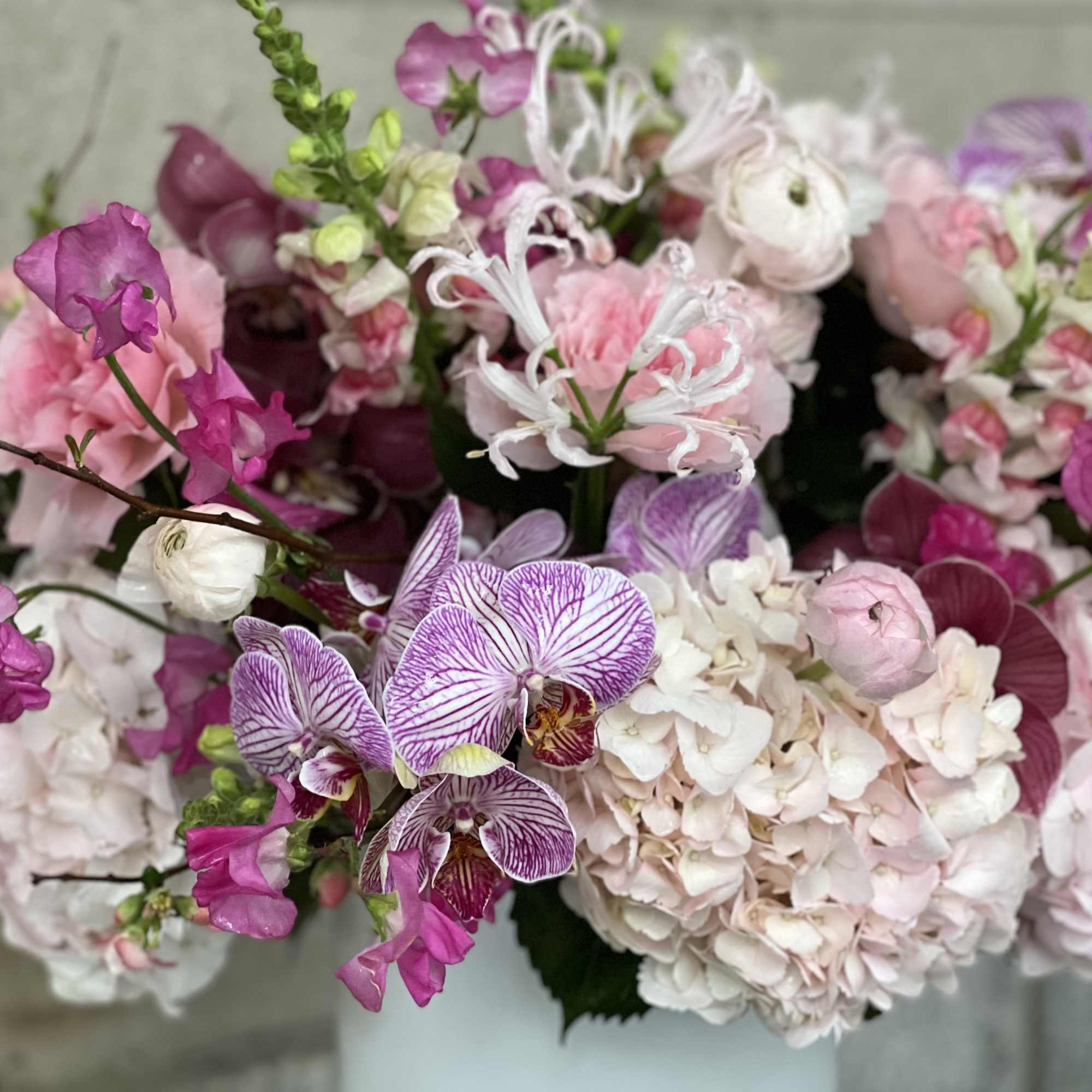 Pink and white floral bouquet with orchids and hydrangeas