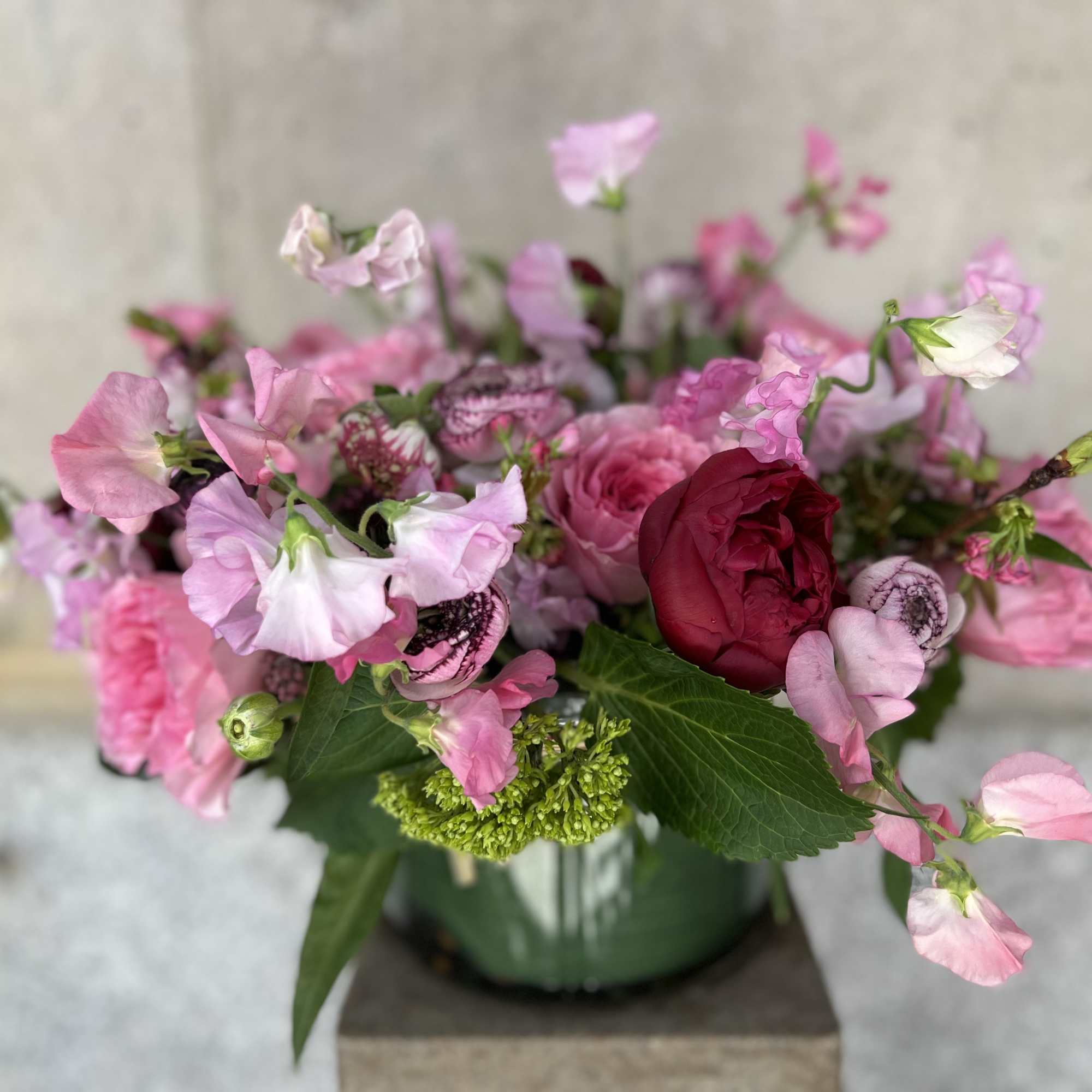 This elegant arrangement, complemented by swirling garden roses , soft and subtle
