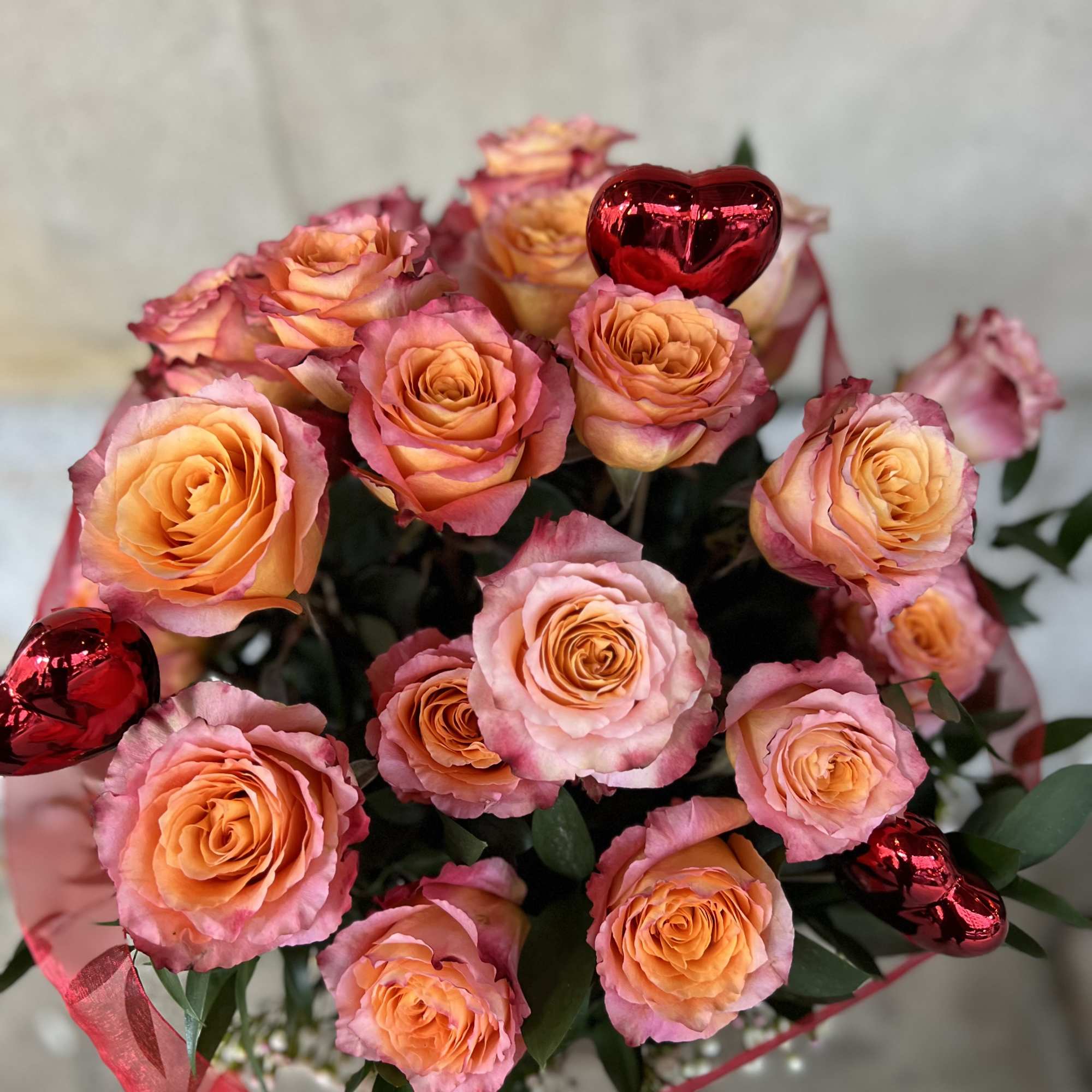 Bouquet of peach and pink roses with red heart decorations, photo 6 of 7