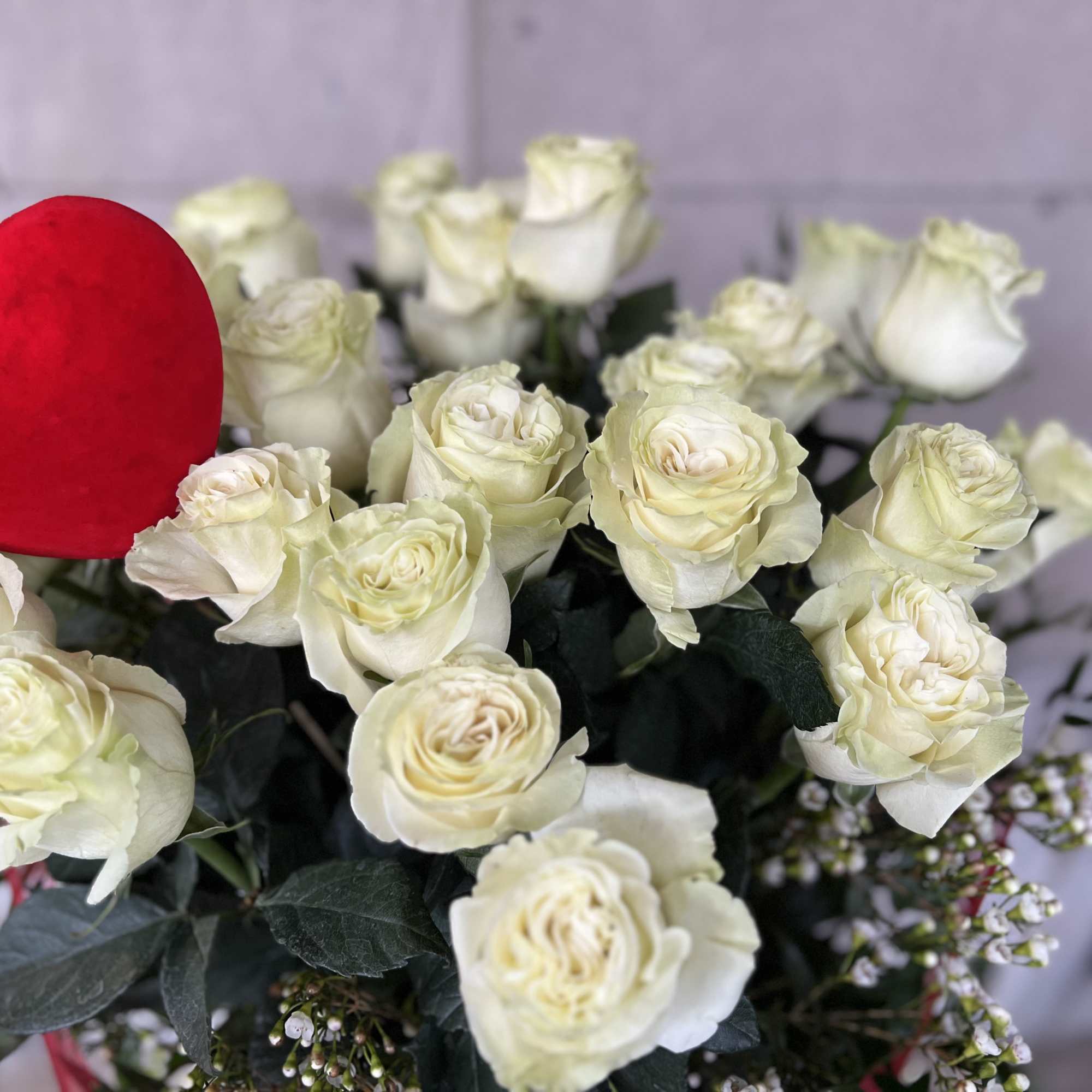 White roses with a red heart decoration