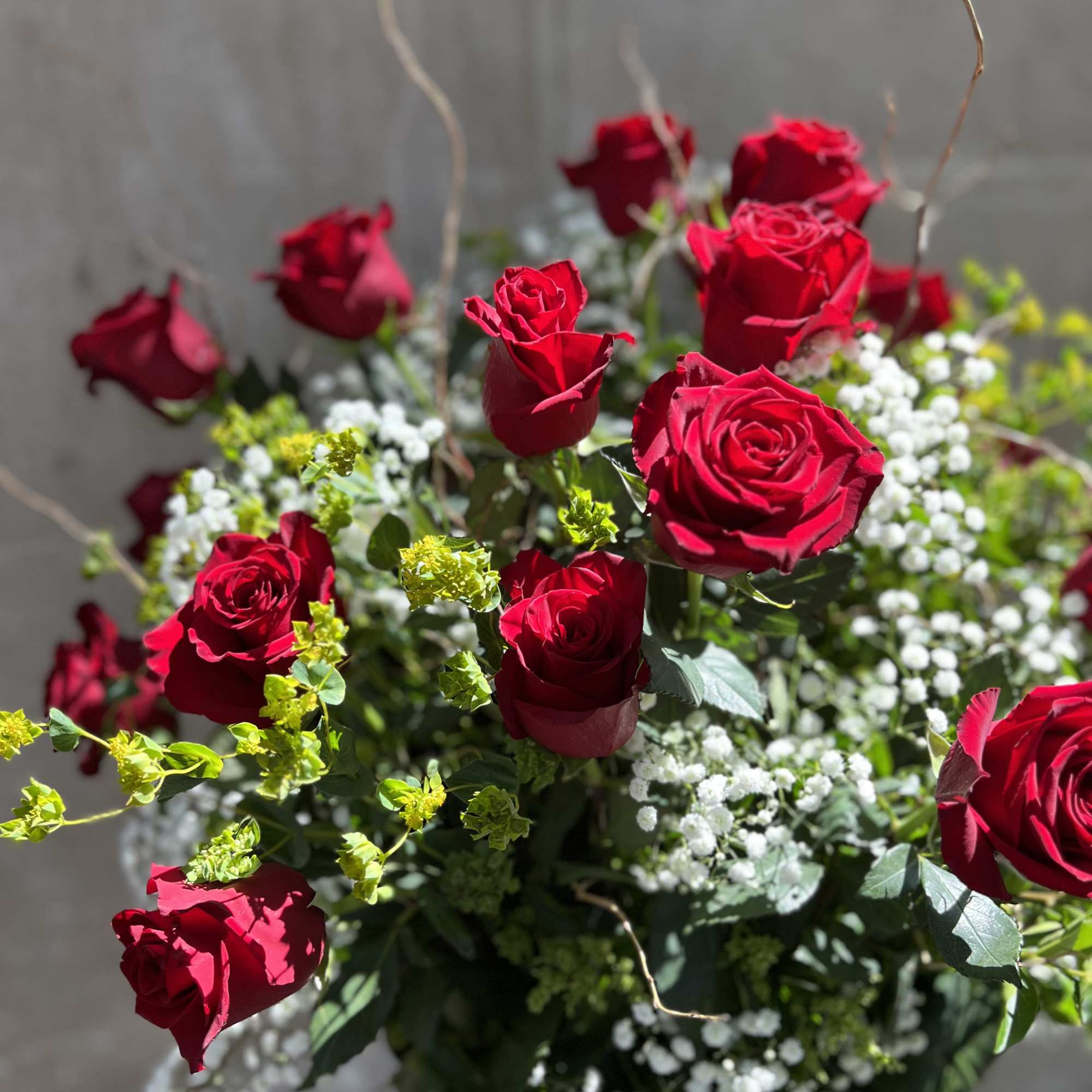 Bouquet of red roses with white baby's breath and green filler